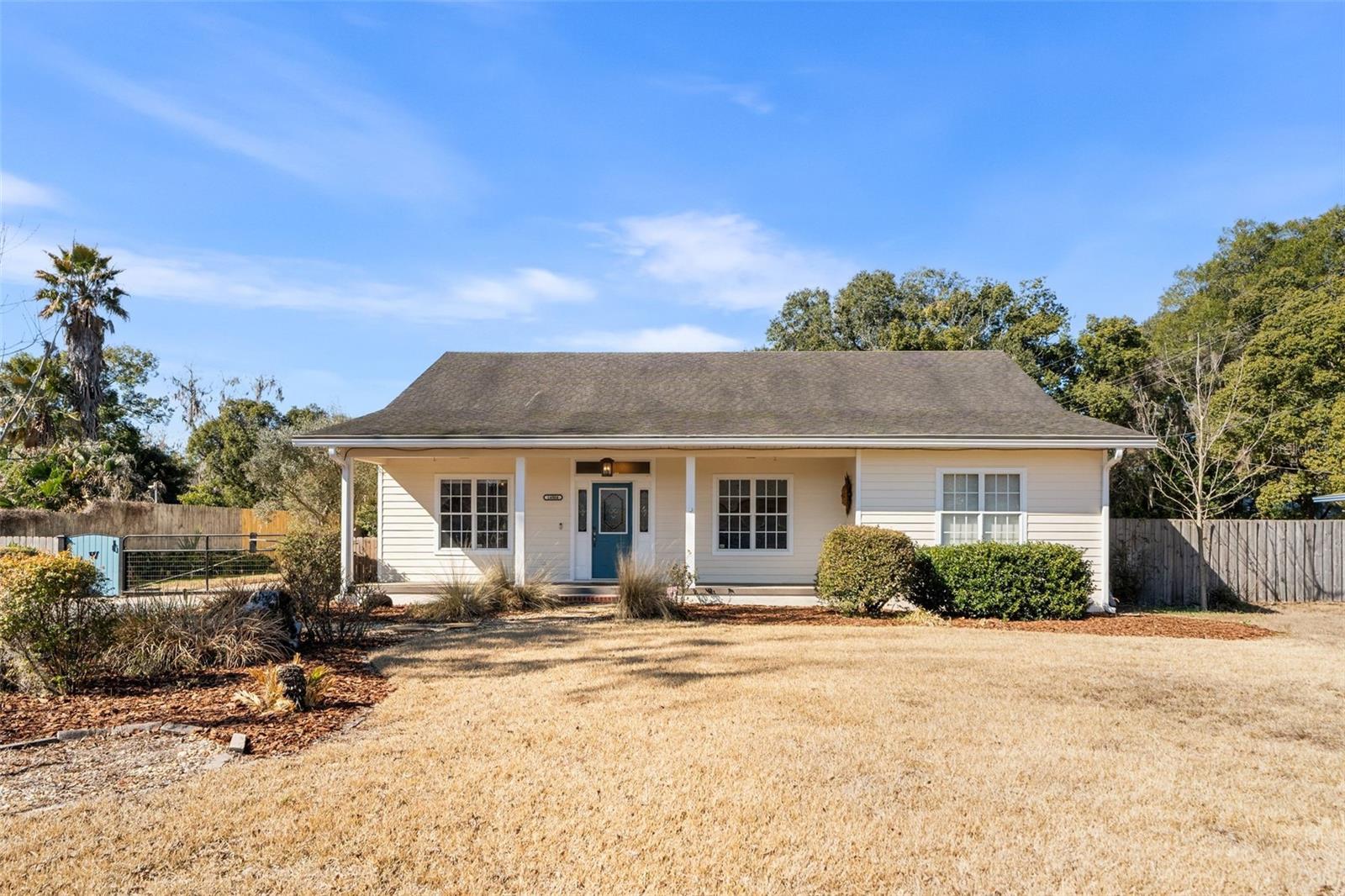 This Beautiful one owner home was custom built for an active lifestyle and casual enjoyment with an open floor plan that has lots of natural light throughout. The carport is perfect for those with larger vehicles with 8ft. height and storage along one wall plus an attached studio/workshop with roll door and A/C. The sidewalk leads to the French doors that open to a 24x36 Detached Workshop with 50 gal 230v Air Compressor, A/C and Ht., tankless water heater and  several skylights for natural light, automatic bay doors, a bathroom and kitchen area. It could be easily converted to an ADU for a second family or Air BnB and still have room for a shop. The main home has plenty of room to spread out including an office/study with built in bookshelves and glassed French doors and a separate dining room that could be a second office or music room. The fully equipped kitchen has a gas range, oven with a warming drawer, counter depth refrigerator, and prep sink in the island. Breakfast area can accommodate a small bistro or a larger dining room table. The great room has a gas fireplace with French doors that open onto a huge family room that is the perfect spot for entertaining family and friends. It has two living areas, a wet bar and coffee station, Spa and sliding glass windows overlooking private yard. There is also a garden storage shed for lawn and landscape tools. There is also large 16 ft. gates on the back side with a perfect spot for your boat and RV with sewer dump station . The total property for house and shop is .8 acres and can be accessed by the back of the property on 142nd St. or through the 10 ft. automatic swing front Gate on 143rd Terrace next to the house. There is a second tax parcel that is 1/2 Acre also connected to city water and sewer and is approved for a single home, Mobile hoe or Granny Flat could be used for income rental or additional living space and seller will consider selling the extra lot for with the home for $388,800. Main home has New Hot water 2026, A/C 2025 and for acceptable offer a New roof at closing on home and carport with attached workshop. This is move in ready! Convenient location only 15 minutes to The Gainesville Regional Airport and 20 minutes to downtown Gainesville. Close to lakes for fishing and boating with a 9 minute drive to Lake Alto Boat Ramp and 16 minute drive to Big Lake Santa Fe Boat Ramp. Just down the street from the boat ramp is Melrose Bay Park that has beach and water access. (Picture of park and lake in Photos)Brochures available on request.