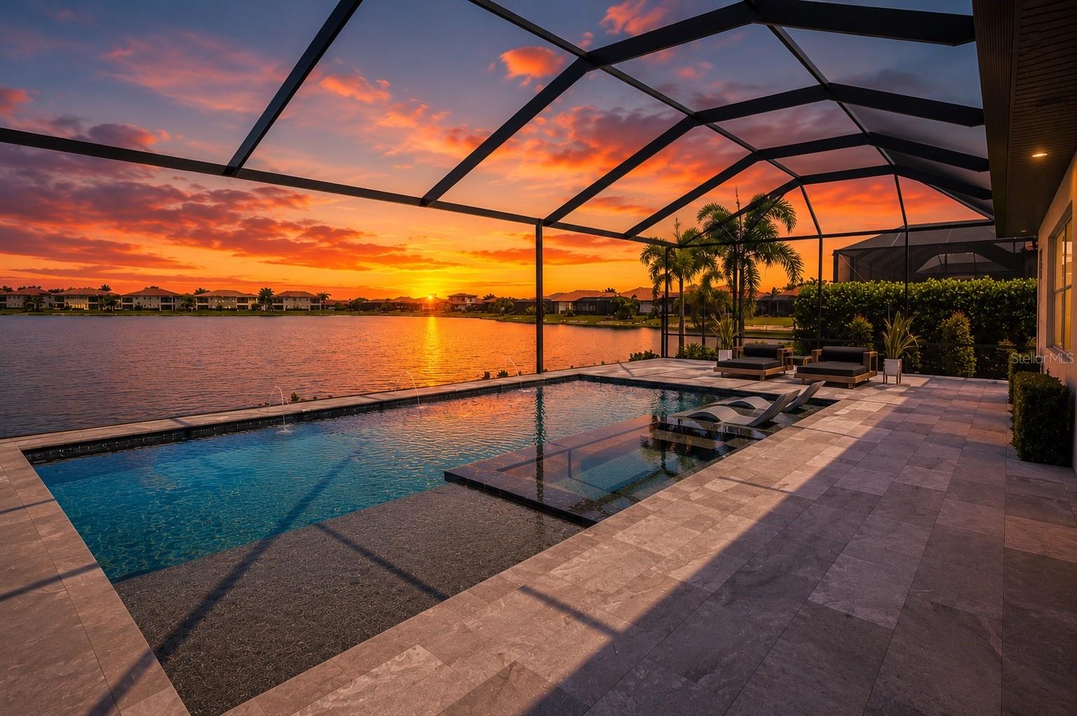 Virtually Staged. Luxury Waterfront Living in Toscana Isles

Experience refined Florida living in this meticulously maintained and extensively upgraded lakefront residence, perfectly positioned on a premium east-facing homesite within the highly sought-after gated community of Toscana Isles. Offering breathtaking sunrise views across the water, exceptional designer finishes, and a spectacular custom resort-style backyard, this home has been thoughtfully transformed well beyond builder specifications while being impeccably cared for inside and out.

Offering 3 bedrooms, a spacious den, 2 full bathrooms, 2 half bathrooms—including a convenient pool bath—and a tandem 3-car garage, this exceptional residence combines luxury, functionality, and effortless indoor-outdoor living.

The light-filled open floor plan showcases elegant tray ceilings, custom shiplap accents, designer lighting, a stunning fireplace feature wall, and a beautifully redesigned gourmet kitchen featuring quartz countertops, upgraded cabinetry, designer backsplash, stainless steel appliances, and an oversized island with custom architectural wood detailing. A striking custom wine display serves as both functional storage and a stunning focal point, while the versatile den offers the perfect space for a home office, media room, playroom, or additional living area.

The true showpiece of this home is the extraordinary waterfront backyard retreat. Designed for year-round Florida living and entertaining, the expansive screened lanai showcases an approximately $150,000 custom outdoor transformation featuring an 18’ x 30’ heated saltwater pool with a raised spa, sun shelf, elegant water features, premium Pentair automation, and over 1,000 square feet of luxurious leathered marble pavers. The covered outdoor living room features a custom wood ceiling, a fully equipped outdoor kitchen, dedicated pool bath, and seamless sliding glass doors that blur the line between indoor and outdoor living. Framed by tranquil lake views and coveted eastern exposure, this private oasis offers the perfect setting to enjoy peaceful sunrises, entertain guests, or simply unwind in your own waterfront paradise.

The spacious owner’s suite provides a relaxing retreat with a spa-inspired ensuite featuring dual vanities, quartz countertops, an oversized frameless glass shower, soaking tub, generous walk-in closet, and elegant designer finishes throughout.

Car enthusiasts and hobbyists will appreciate the professionally finished tandem 3-car garage featuring epoxy flooring, built-in mini-split air conditioning, upgraded LED lighting, and a vehicle lift available for purchase or included.

Residents of Toscana Isles enjoy exceptional resort-style amenities including a gated entrance, clubhouse, fitness center, resort pool, tennis and pickleball courts, scenic walking trails, and over 200 acres of interconnected lakes perfect for kayaking and fishing. Conveniently located just minutes from Nokomis Beach, Venice Island, Sarasota Memorial Hospital, shopping, dining, and I-75, this home offers an exceptional blend of luxury, comfort, and convenience.

This is more than a home—it’s a private waterfront resort designed for the Florida lifestyle.