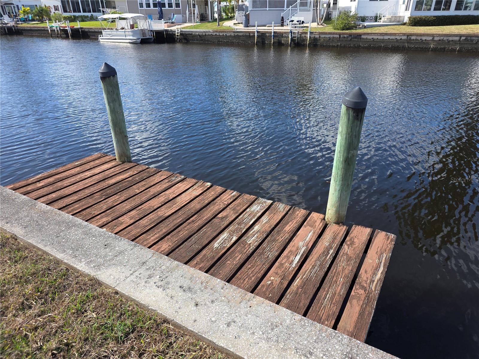 Want a great spot to install your brand new manufactured home in Southwest Florida?
THIS IS IT!!  Quiet cul-de-sac lot with a dock, close to the clubhouse and pools.
Fish from your back yard or take your boat out on a cruise down the Myakka River to Charlotte Harbor and/or the Gulf.
Harbor Cove - Voted BEST Manufactured Home Community by North Port Sun Reader's Choice.  Offering a private community boat ramp, 90 slip marina, two story clubhouse, two heated pools, hot tub, bocce, tennis, pickle ball, fitness, storage grounds, wood working shop, crafts dinners, dances, entertainment and more.  Easy commutes to Sarasota and Fort Myers.  Minutes from the gulf beaches, Myakka River, Peace River, Charlotte Harbor, restaurants, shopping, Tampa Bay Rays summer training stadium, Warm Mineral Springs Health Spa, Cool Today stadium for the Atlanta Braves, and the SunSeeker Resort located in Charlotte Harbor.  EVERYTHING you need for your waterfront lifestyle is here in Southwest Florida.
Buyer has one year to decide on a builder and home to install.
Need a builder?  I can help with that.