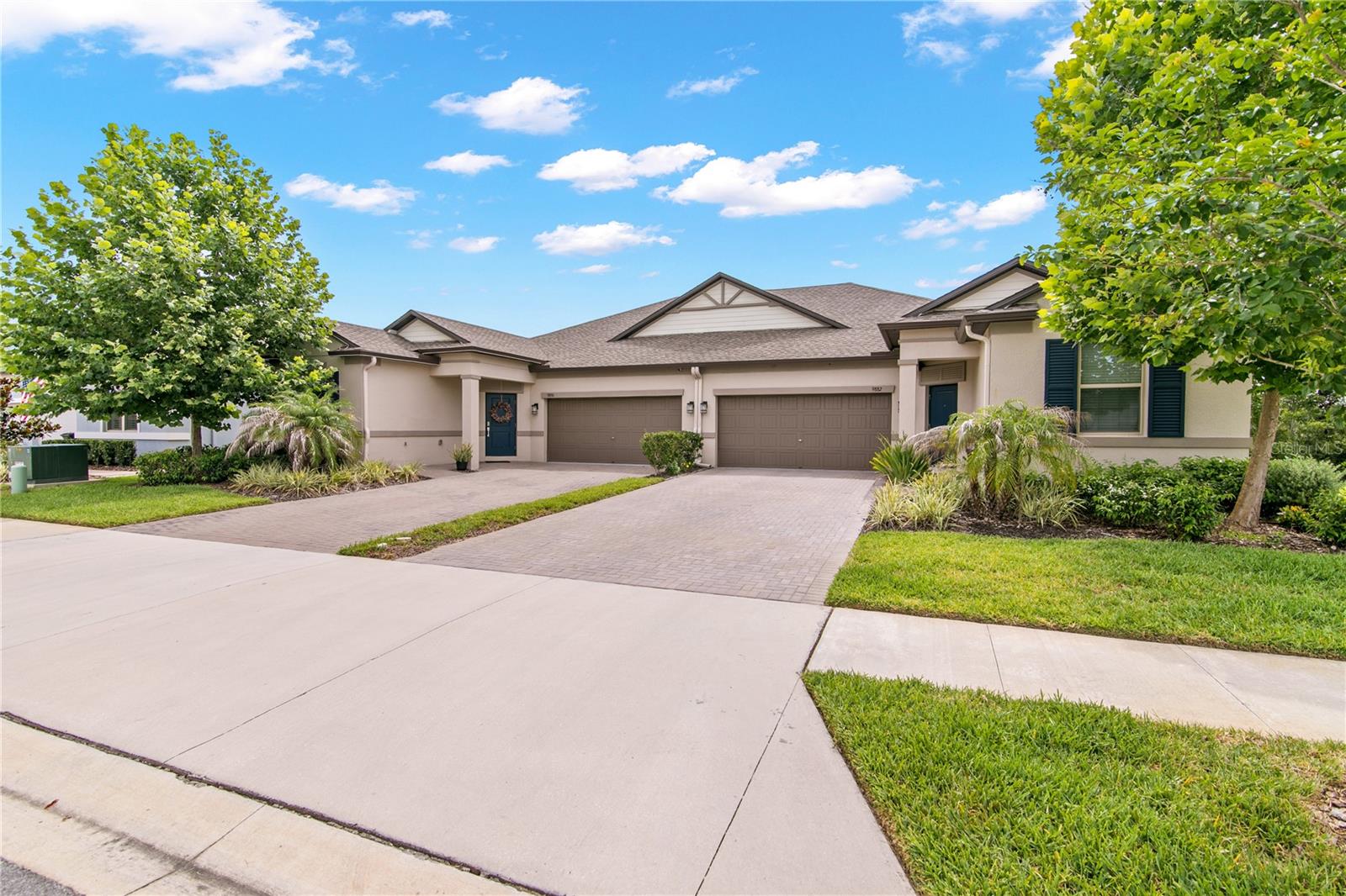 Welcome home to this better than new villa in Connerton! You'll love this CONSERVATION VIEW end unit with LUXE finishes throughout. You'll love the beautiful kitchen with QUARTZ countertops and white shaker style cabinetry, stainless appliances, and large pantry. Fashionable WOOD-LOOK TILE floors run throughout the living spaces, and CROWN MOULDINGS throughout with tray ceilings really give this home an elegant look. Your primary suite features an upgraded bathroom with glass shower surround and dual vanities with QUARTZ countertops.  The closet is a show-stopper with a FULL CUSTOM CLOSET BUILDOUT like you'd find in a luxury home. If you entertain, you'll love the TEN-FOOT (approx) CEILINGS, open floor plan, and screened rear lanai with ultimate PRIVACY.  Storage and utility is tremendous with CUSTOM CLOSETS in both guest rooms, a full laundry room with cabinets, a command center, and two-car garage.  WATER, LAWN MAINTENANCE, IRRIGATION, EXTERIOR MAINTENANCE, CLUBHOUSE, POOL, FITNESS CENTER are all included.  The new construction units can't touch this QUALITY OF UPGRADES!