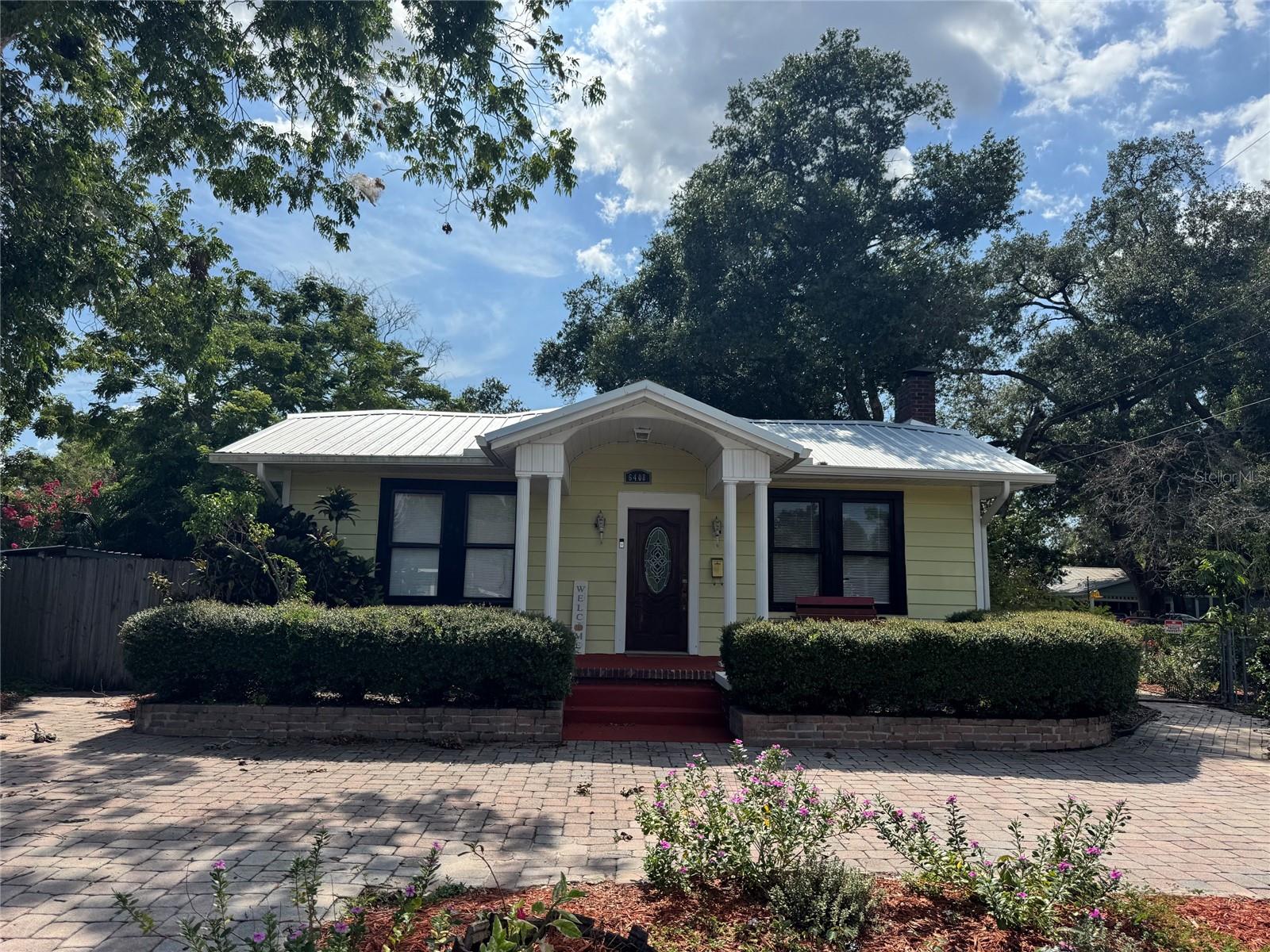 Charming Craftsman Bungalow with Income-Producing ADU in Sought-After Seminole Heights!

Filled with character and income potential, this beautifully maintained Craftsman bungalow on the west side of Seminole Heights offers the perfect blend of historic charm and modern updates. Enjoy original hardwood floors throughout, a cozy gas fireplace in the living room, and abundant natural light from lovingly restored original windows. The home features two spacious bedrooms (each approximately 10x12), a formal dining room, and an adorable breakfast alcove perfect for casual meals.

The large primary bathroom (75" x 134") is a true standout, complete with a walk-in closet, garden tub, and separate shower. Additional updates include a new metal roof (2024), tankless hot water heater (2024), and convenient in-home laundry. The home was professionally tented for termites and remains on an annual termite protection plan.

Step outside to your private, fully fenced tropical oasis featuring a paved walkway, covered front and side porches, a circular driveway, and a separate storage shed.

Bonus: Income-Producing ADU
The charming 450 sq ft detached ADU offers its own bedroom/living area, kitchenette, and a spacious bathroom (75" x 134") with tiled shower—ideal as a rental, guest suite, private office, or multi-generational living space. Generate strong rental income or enjoy the flexibility of dual living.

Prime Location
Just a 5-minute walk to the Hillsborough River, 12 minutes to Armature Works, 14 minutes to the Tampa Convention Center, and 15 minutes to the University of South Florida, with quick access to I-275.
This rare Seminole Heights opportunity combines classic Craftsman details, modern systems, privacy, and real income potential. Don’t miss your chance to own a versatile home with an ADU in one of Tampa’s most desirable neighborhoods!