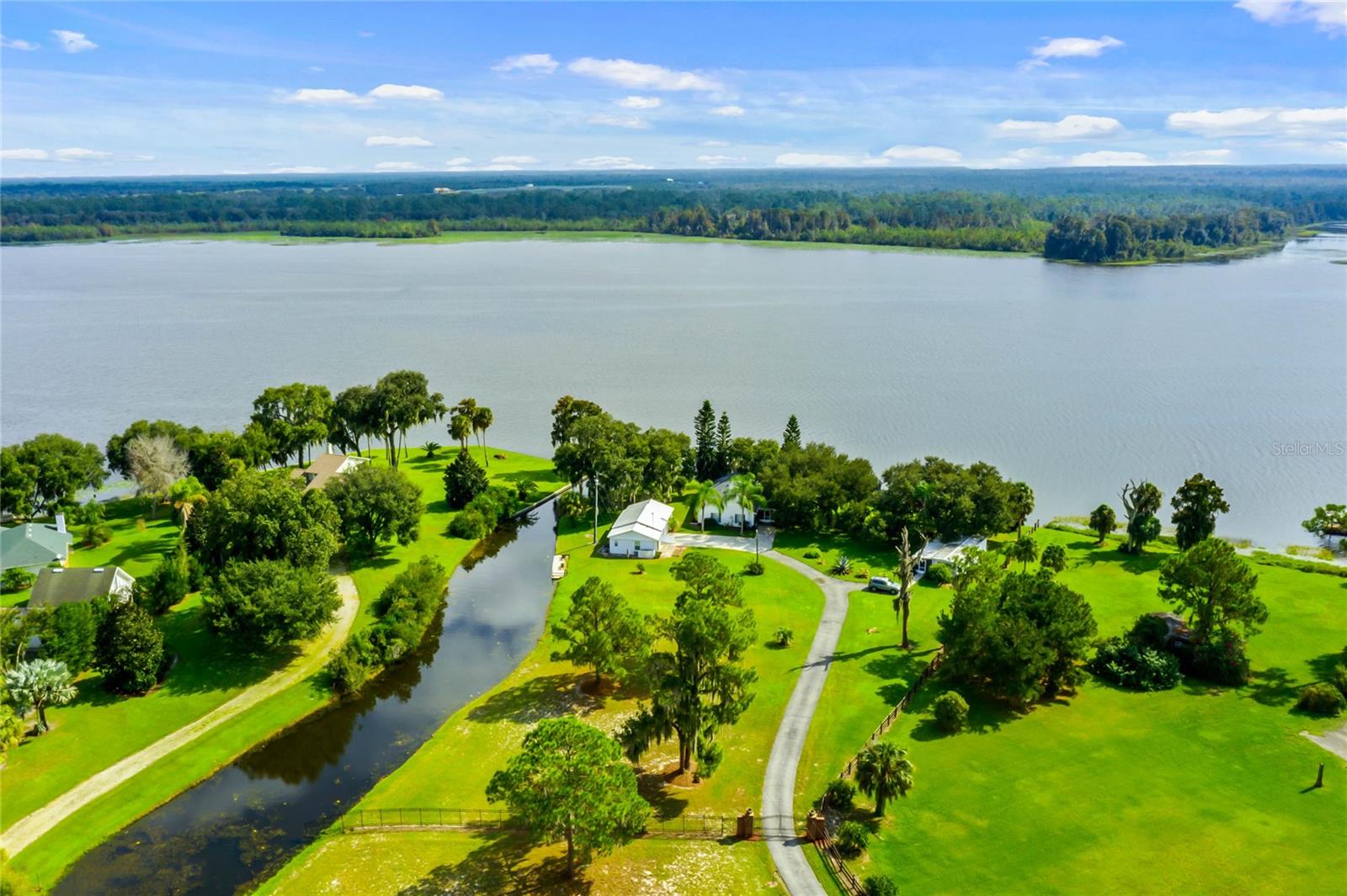 Welcome home to your future lakefront retreat!
This enchanting property offers breathtaking views of Lake Pierce and sits on nearly 2 acres of lush, tranquil land. Designed as a family compound, it features a main house, two studio apartments, and a 2-bedroom, 1-bath mobile home, making it a truly unique and versatile lakeside haven.

The main residence offers 2 bedrooms and 2 bathrooms, thoughtfully positioned to maximize the stunning waterfront views. The eat-in kitchen includes a center island, oak cabinetry, and a reverse osmosis water filtration system. The expansive great room is adorned with French doors that open to a screened-in lanai, nestled under the shade of a majestic oak tree and surrounded by lush tropical landscaping.

The primary bedroom suite includes dual closets and a private ensuite bathroom. The inviting front porch provides the perfect spot to relax and soak in the inspiring views of Lake Pierce.

Because the property spans both the lakefront and canal, it offers an excellent opportunity for floatplane access—a rare and valuable feature for aviation enthusiasts.

The 3-car garage includes enough space for a work shop or extra storage space.

Each of the two studio apartments features: Tile flooring, Ventless air-conditioning systems, Remodeled bathrooms, Tankless water heaters and Updated electrical panels

The 2-bedroom, 1-bath mobile home is being offered fully furnished and turn key ready.  Featuring a  screened-in porch, new hot water heater (2024) and Off-street parking. 

Additional Upgrades & Amenities: Main house roof replaced in 2018, New 3-ton AC unit (2024), New water heater (2024), Hurricane shutters, Utility room, Canal-front dock, Irrigation system with new Rainbird control panel, Water filtration system, Paved driveway, Private, gated entrance.
A Tranquil Lakeside Sanctuary Tucked away behind a private gate, this picturesque retreat radiates Old World charm and peaceful seclusion—the perfect escape from the hustle and bustle of modern life. Conveniently located just 45 minutes from Disney, it combines privacy, versatility, and access to nature in one extraordinary package.