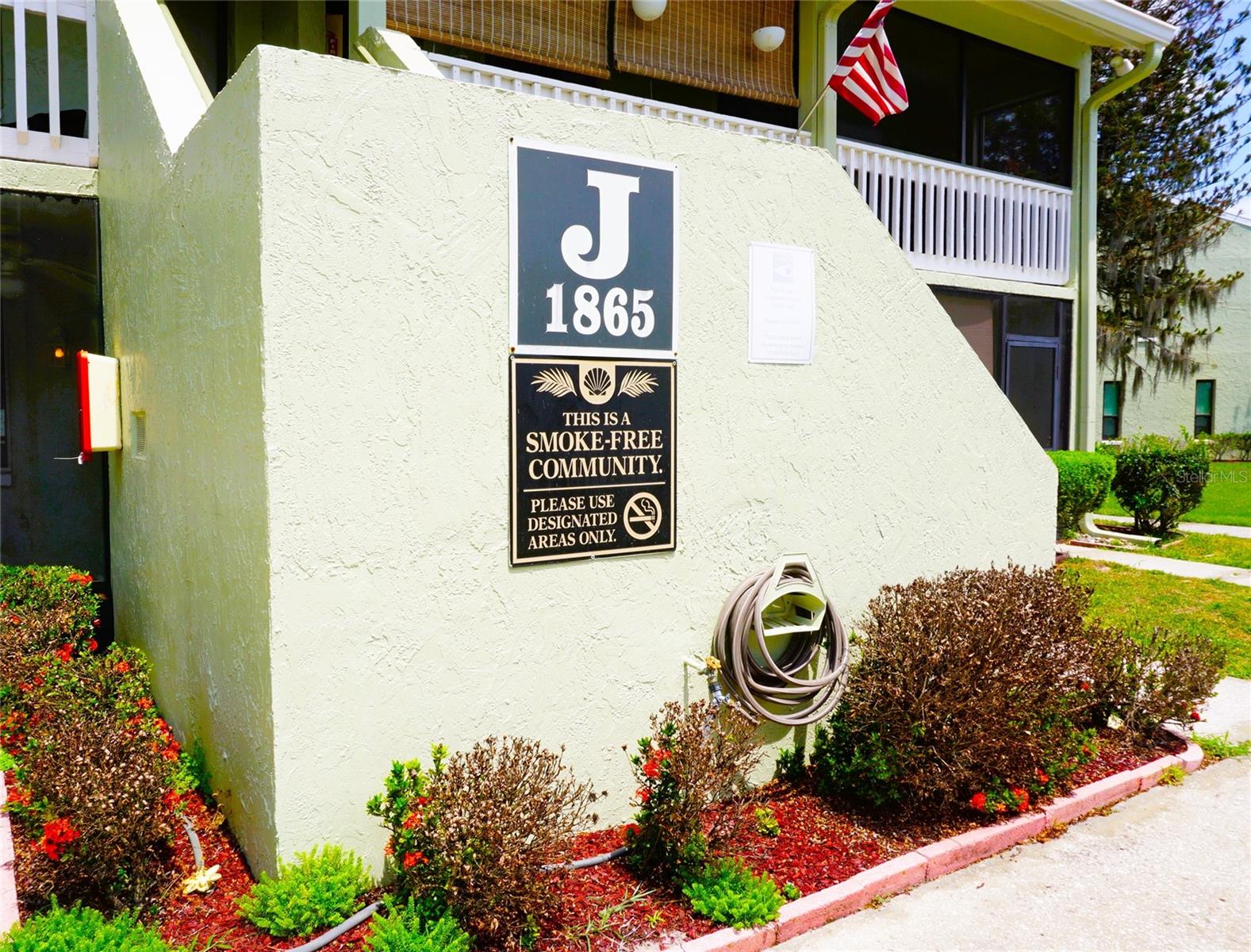 Owner Financing Available! Enjoy expansive water views from this 1-Bed/1-Bath ground level condo in the gated nudist/clothing-optional community of Paradise Lakes. Neutral carpet, laminate, and tile throughout. The kitchen features a solid surface extended counter, 4-burner stove, refrigerator, microwave, dual stainless sink, and upper/lower pantry cabinets. Spacious bedroom with built-in desk, closet, and full-size washer/dryer for convenience. Bath has a tub/shower with sliding glass doors and vanity with granite top. Mirror accent wall in living room. Bedroom has mirror on the ceiling. Bar set-up in living room with solid surface counter is perfect for entertaining. The screened covered lanai with water views offers outdoor living space. Buyer is responsible for verifying all information, details and dimensions. Condo association approval of Buyer is required including application, fee, background check, orientation, and membership in a recognized nudist organization. Optional membership to Paradise Lakes Resort is not included in monthly condo association fee.