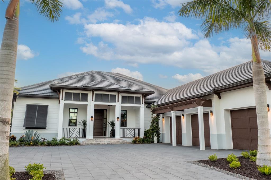 MASSIVE PRICE REDUCTION…Now with Optional Furniture Package. Live the ultimate luxury Florida lifestyle in this masterfully designed and furnished showpiece that blends the British West Indies and Contemporary architectural styles. Located in The Lake Club, this green certified, former model home by Murray Homes was awarded Parade of Homes Best Overall Home award and since has been further upgraded with jaw-dropping details and luxury lighting fixtures. Built for entertaining, combine both indoor and outdoor living with over 2,200 square feet of covered lanai space with gas fire place and fully equipped outdoor kitchen overlooking the salt water pool and spa. The 
 two poolside casitas are perfect additions and can be used as in-law suites, home theater, or office/studio.  The attention to detail throughout the home’s 3,618 square feet is astounding. The kitchen has been recently updated to include quartzite and Calcutta marble countertops, and has gourmet appliances to impress the most discerning home chef. The beautiful wood flooring leads through the home and accents the designer's vision with high-end lighting fixtures and ceiling details. The home has been outfitted with Crestron smart home features including motorized shades and speakers to surround you with music. The owner’s suite is the perfect place to relax with access to the lanai, large walk in closets, and a spacious bath with soaking tub and separate shower. The Lake Club offers resort-style amenities including swimming pools, billiard & game rooms, tennis and pickle ball courts, fitness center, massage & skincare rooms, dining room with in house chef, 24 hour guard, trails, parks, lakes and more. Furniture package in the home designed by Restoration Hardware Gallery of Tampa is available for purchase. No need to wait for new construction or long furniture order delays, start living the ultimate luxury lifestyle.