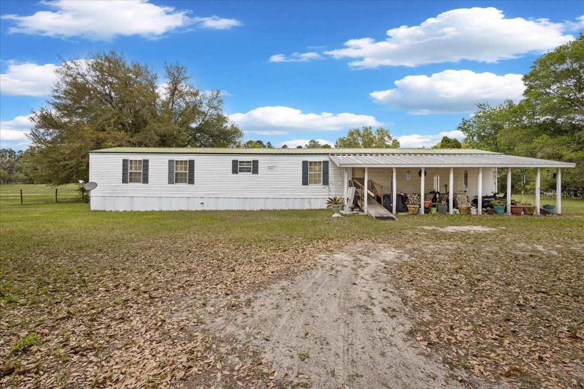 ONLY 11 minutes from High Springs , this amazing 2/2 SWMH located on 5 gorgeous acres in the countryside of Columbia County is JUST the home you've been looking for.  Such a gorgeous and easy drive to the country you find yourself only a few minutes away from several great towns for all your dining and shopping needs. This home offers 2 bedroom suites with full on bathroom suites, that offer dual vanities, a nice garden tub and walk in shower each. A spacious living room, spacious kitchen with dining room and laundry room. A gorgeous front patio perfect to enjoy Floridas year round warm temps. Property is fenced and cross fenced set up for all your farm animals, family and pets. Bring you horses, perfectly set up being cross fenced pets. Bring you horses, perfectly set up being cross fenced all you need is a barn. Not into animals? Imagine using the land for rental income! Home has been extremely well maintained. Metal roof, AC approx 3 years old, hot water heater approx 4 years old and well/ filtration system are brand new! Call today for YOUR tour!