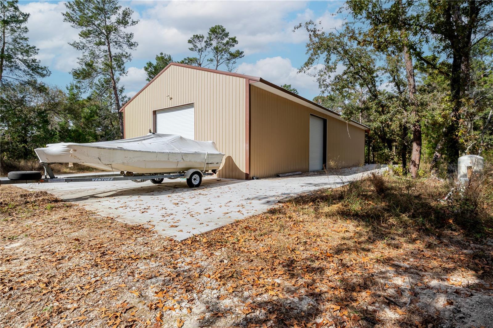 9.66 Acre, Ready to build!!  Property boasts a 40x80 Steel Building, 16 Ft Tall, completed in 2024.  Property already has well and septic.   Building includes overhang for covered RV parking with hookups. New Washer and Dryer in the building.