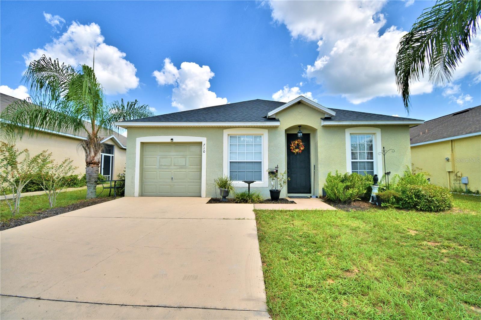 This home is close to everything, shopping, doctors' offices, grocery stores and I-4.  Seller just did a serious price reduction with this 4 Bedroom, 2 Bath home in a gated community with small Hoa fees.  Brand new air conditioner installed in 3/23, Roof installed in 2019.   Garage is totally air conditioned perfect for a game room or mother in laws quarters.  Washer & dryer are included in this sale.  Kitchen has upgraded kitchen cabinets and a pocket door separating the living room.  Master Bedroom has sliding doors leading to the partial fenced back yard.  Plenty of yard space for a fire pit or just to run around.  Very close to 1-4, 7 miles to Disney, close to sea world and other attractions.  Walking distance to shopping.