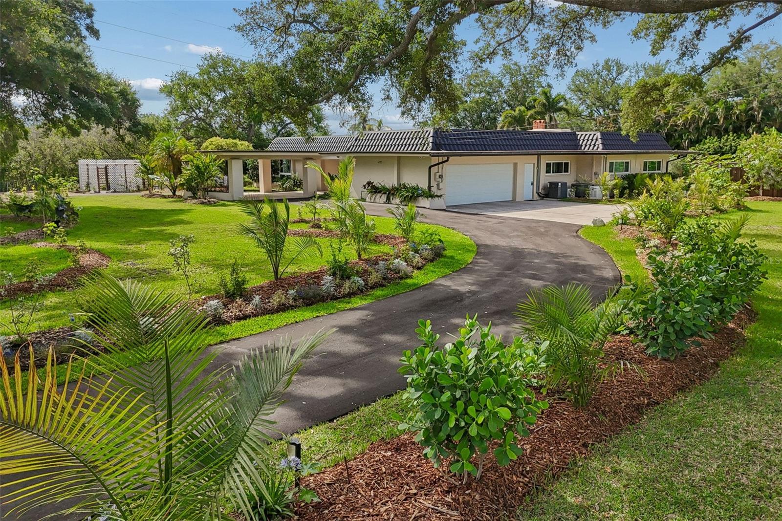 Welcome to your own private oasis, in the heart of Clearwater. This sprawling 5 bedroom 4 bath 3600+ sq ft estate has all the bells and whistles. including water frontage on Allen's Creek.  If you are an outdoor enthusiast, you can fish, paddleboard, and kayak from your own property, or just watch the manatee and other wild life that come in and out. This lovely private gated home features a large chef style kitchen with granite countertops and maple cabinets. Split bedroom floor plan, with large closets throughout the home.  The open floor plan wraps around a gorgeous screened in heated saltwater pool with built in Jacuzzi, a walk in sun shelf and a 9 ft deep end. The large pool entertainment area features a spacious covered area with outdoor kitchen, perfect for entertaining no matter the weather. This spacious well appointed home sits on 2 acres of trees, flower gardens, fruit trees, and vegetable gardens.  Zoning of this unique fenced property allows up to for up to six animals (horses or other hoofed animals). The property even has two horse stables and a vented tack room, currently being used for a few chickens, and for the gardeners, multiple greenhouses. Recent upgrades include newer septic system with lift station, new drive way, and EV station in garage, privacy fence with 2 electronic gates, 2 custom pergolas with water features, fire pit and outdoor sauna. Not to mention the lush, professionally designed landscaping with 1000+ plants and trees with plenty of room to add extra garages for cars and toys!  This lovely home has a whole-house natural gas generator and whole-house water filtration system, gas tankless hot water heaters, impact-rated windows, sliders, doors, and garage door, adding to not only it's value and security, but discounts on insurance. If you are looking for a unique estate, drive through the front gates and fall in love!  Come see it today!