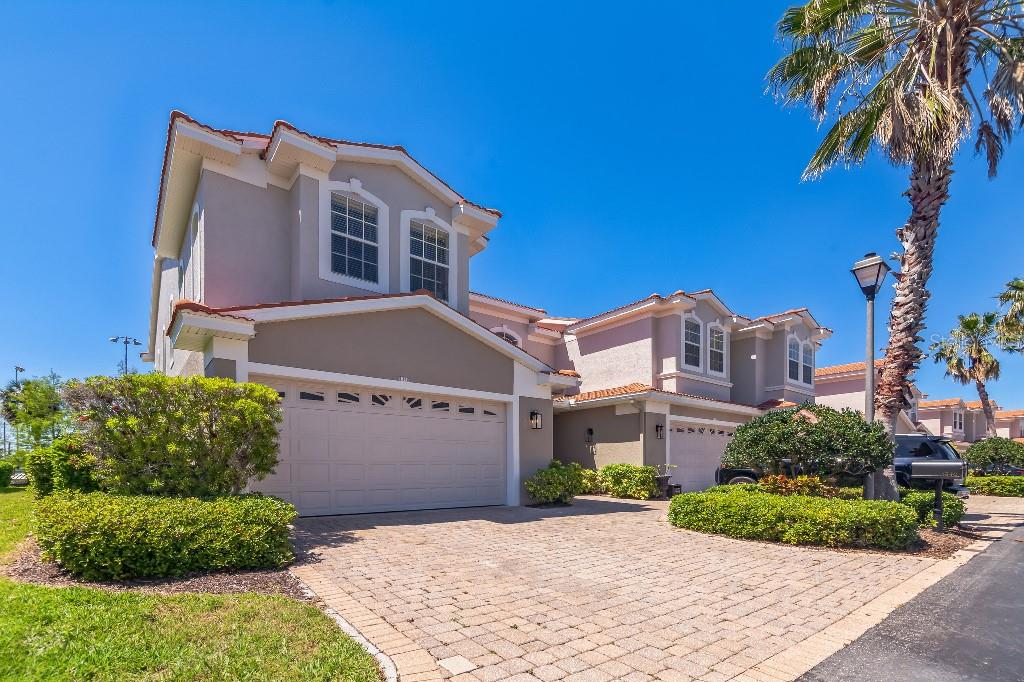 FABULOUS TOWNHOME in gated Villas of San Marino! Step inside the 2-story 22' entrance of this END UNIT to an inviting wood/iron staircase, upgraded kitchen that includes wood cabinets, quartz countertops, stainless steel appliances and a walk-in pantry. Light floods the living room boasting french doors facing the large, private, screened lanai. The upstairs spacious master suite boasts double-door entry, large walk-in closet, and a bonus area great for home office or gym, facing french doors to a private terrace that offers partial gulf view. The master bath offers double sinks, vanity, granite, large glass shower enclosure and garden tub. The second upstairs bedroom suite is also large, with tons of natural light, and its own full bath. The third bedroom is located on the first floor and includes its own full bath with pocket door option for privacy from main living area. Upgrades to the home include first floor plank tile, matching second floor luxury vinyl, nickel light fixtures and hardware throughout, 5 1/4" baseboards, 8' ceilings, recessed lighting, built-ins in all bedroom closets, newer water conditioner, newer quiet garage door opener, 3 yr old HVAC. It is steps from the Pinellas Trail, downtown Palm Harbor, Pop Stansell Park and Sunderman Rec Complex. The neighborhood is zoned for top-rated schools as well. The community has maintenance-free living - cable, WiFi, community heated pool, exterior maintenance including paint, roof, landscaping, and trash are all included in monthly HOA. No flood insurance is required. Don't miss the chance to call this gorgeous townhome YOUR home!