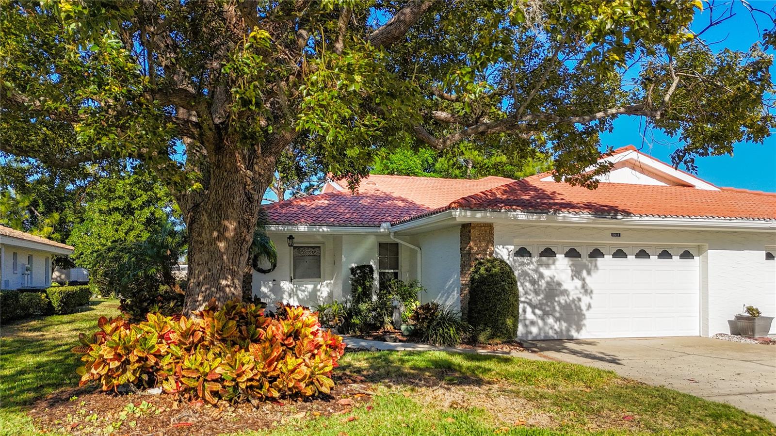 Welcome to Garden Lakes, a beautifully maintained, gated 55+ community designed for active, carefree living. This inviting split-plan 
2-bedroom, 2-bath villa with a 2-car garage offers the perfect blend of privacy, comfort, and convenience. Enjoy peaceful outdoor living from your glass-enclosed, air-conditioned Florida room with elegant slate flooring or relax on the private concrete patio overlooking a walking trail and fenced backdrop — no rear neighbors for added tranquility.

Inside, you’ll find a spacious living and dining room combination with vaulted ceilings, skylights, and abundant natural light. A charming BAY WINDOW with a built-in window seat and hidden storage adds both warmth and functionality. Luxury vinyl plank flooring flows throughout the main living areas, delivering a stylish, low-maintenance finish. The updated kitchen showcases solid surface countertops, refreshed cabinetry, a 2024 refrigerator, and a cozy eat-in dining nook.  A convenient pass-through to the dining room makes entertaining effortless.
The primary suite offers a walk-in closet and peaceful retreat.  The guest bedroom and bath can be closed off with a pocket door, creating a private ensuite space for visiting family and friends. Accessibility features include French doors for easier furniture placement and a wheelchair ramp entry through the garage. Additional highlights include epoxy finished garage floor, separate laundry room, AC (2018) and water heater (2021).  Enjoy a short stroll to the clubhouse, heated pool, fitness center, tennis and pickleball courts, and shuffleboard.  The vibrant lifestyle of Garden Lakes Villas awaits.  Ideally located near University Town Center, I-75, medical facilities, dining, and the beautiful beaches and cultural attractions of Sarasota and Bradenton, this villa truly offers the best of Florida living.

Move in, relax, and start enjoying the lifestyle you deserve.