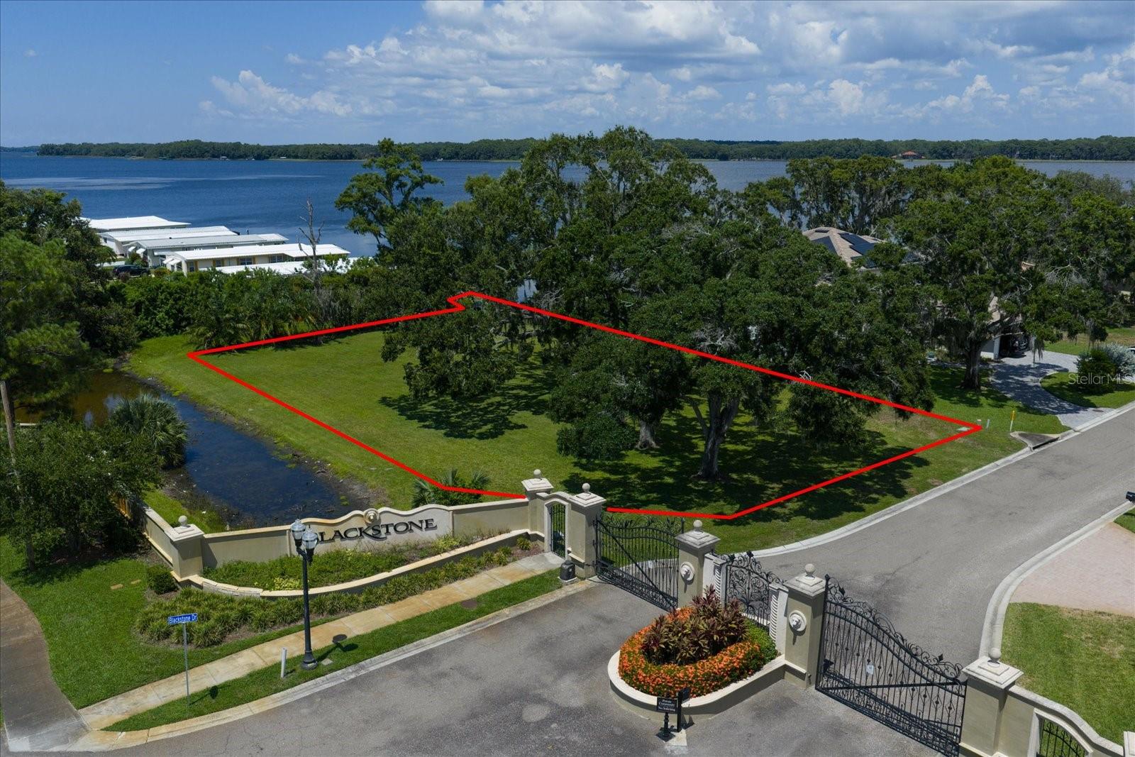 Discover an incredible opportunity to create your dream home in the prestigious Blackstone gated community on beautiful Lake Tarpon. This expansive lot offers a rare chance to build in one of Tampa Bay’s most coveted waterfront neighborhoods, surrounded by exquisite custom estates and timeless architecture.
Enjoy a limited water view of scenic Lake Tarpon from your future home, with full water access to launch kayaks, paddleboards and canoes. Take advantage of Blackstone’s elegant setting, where homes are thoughtfully designed with a minimum of 3,500 square feet to preserve the upscale character of the community. With its private street, serene setting and stunning residences, Blackstone stands out as a premier address for discerning buyers. Location is everything—just off US 19 north of Alderman Road, you’ll have effortless access to dining, shopping, and major thoroughfares while enjoying the peaceful retreat of a private, gated enclave. Lake Tarpon itself is a recreational haven, known for boating, fishing, and lakeside dining, with marinas and parks just minutes away. This lot does NOT require pilings for construction, offering a strong foundation for your vision of a luxury home. The Engineering Report has been completed. Whether you imagine a modern masterpiece or a classic estate, this property provides the ideal setting to bring your plans to life.
Don’t miss the chance to secure your place in this exclusive waterfront community—build your dream home and live the Blackstone lifestyle on Lake Tarpon.