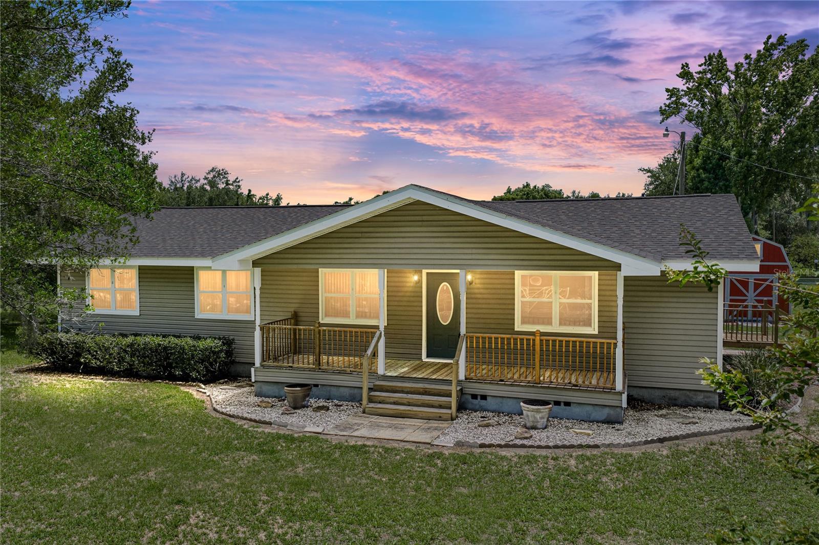One or more photo(s) has been virtually staged. Perfectly placed on 1.25 acres with agricultural zoning and a brand new 2026 roof, this 2 bedroom, 2 bath home offers wide-open outdoor space in a central location just a short drive from Zephyrhills and Wesley Chapel! The expansive corner lot gives the property a sense of openness from the start, with a covered front porch, open back deck, storage shed, and a freshly pressure-washed exterior ready for its next owners. Inside, laminate flooring runs throughout the main living areas, beginning in the spacious 22x13 living room. The layout flows easily into the kitchen, where generous cabinet storage, a microwave, range, and refrigerator create a practical setup. On one side of the kitchen, a mud room leads into the laundry room and could easily serve as additional pantry storage, or overflow household storage. On the other side, the dedicated formal dining room offers a comfortable place to host meals and features sliding glass doors that open to the back deck. Down the hall, both bedrooms and bathrooms are conveniently placed together. The 20x10 primary bedroom provides plenty of room to unwind, along with generous closet space and an ensuite bathroom with a tub/shower combination. A second bedroom and full bathroom add flexibility for guests and additional family. Outdoors, the 1.25 acre lawn gives you room to spread out, garden, bring animals, or shape the property around your needs. With agricultural zoning, a useful storage shed, and an open homesite in a convenient location, this property is a wonderful opportunity for those looking for space without feeling far from town. Call today to schedule your private showing!