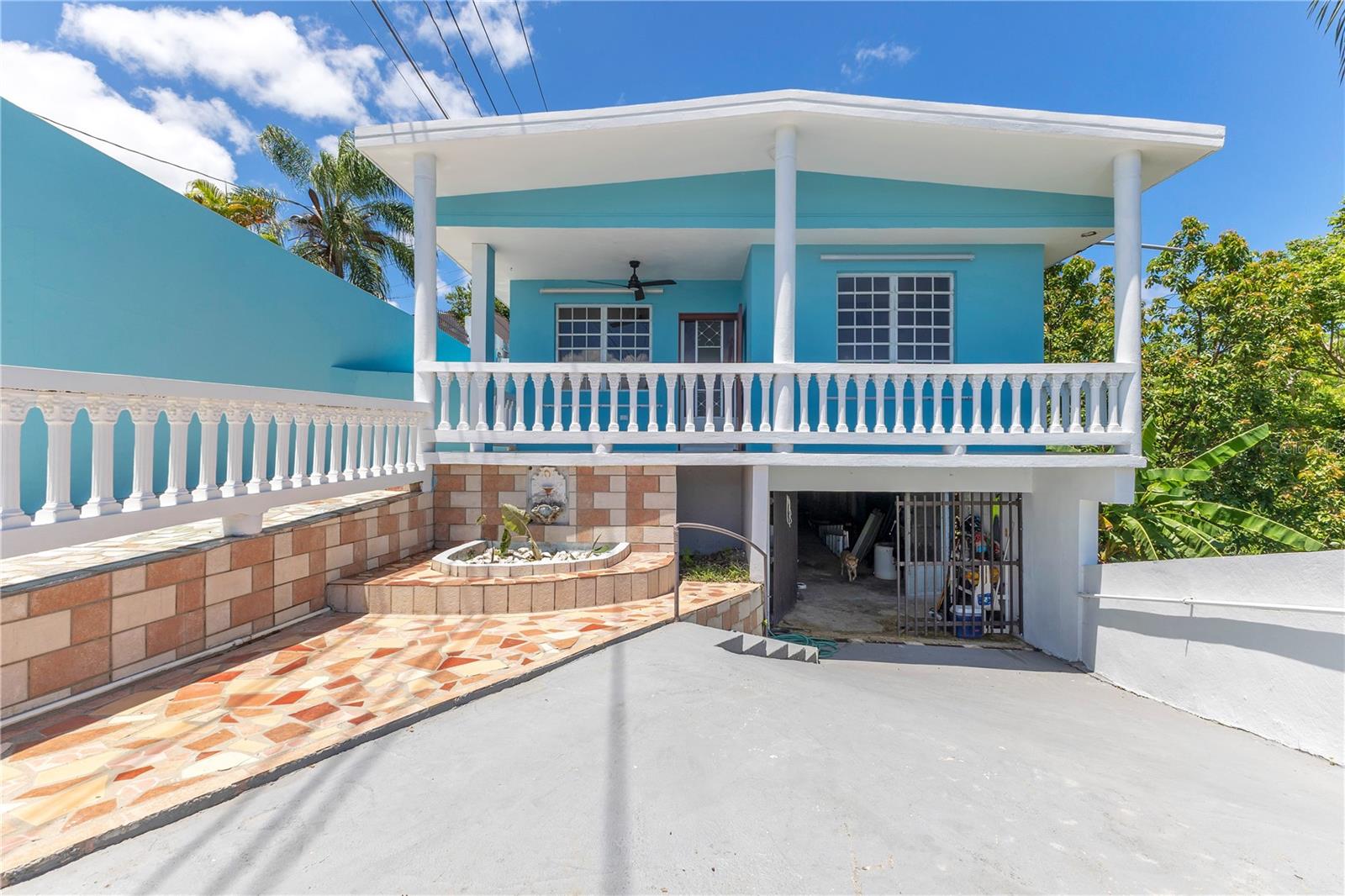 Tucked away in the peaceful neighborhood of Río Grande, Rincón, just minutes from downtown and the beaches, this versatile property offers privacy, space, and income potential on over an acre of lush, fruit-bearing land.
Ideal for a work-live-play lifestyle, private retreat, or income-producing compound, the main residence features 3 bedrooms and 2 bathrooms, including a private primary suite with balcony. The open kitchen offers an island and pantry, complemented by a separate living room, laundry area, and additional storage.
The home is equipped with a backup solar system, while remaining connected to city water and power for convenience. Located on an asphalt-paved road, the property offers easy year-round access. Beneath the main house, you’ll find generous storage space, ideal for tools, equipment, or future customization. A creek borders the property, adding natural beauty and a serene tropical backdrop.
A detached 1BR/1BA casita with kitchenette and living space provides flexibility for guests, extended family, rental income, or creative studio use. An additional partially built structure offers potential for a future studio, office, or second casita.
Situated on a quiet dead-end road in an area experiencing new construction and growth, this property blends tranquility with long-term upside. Convenient access to Route 115, beaches, and restaurants completes the offering.

Schedule your private showing today.