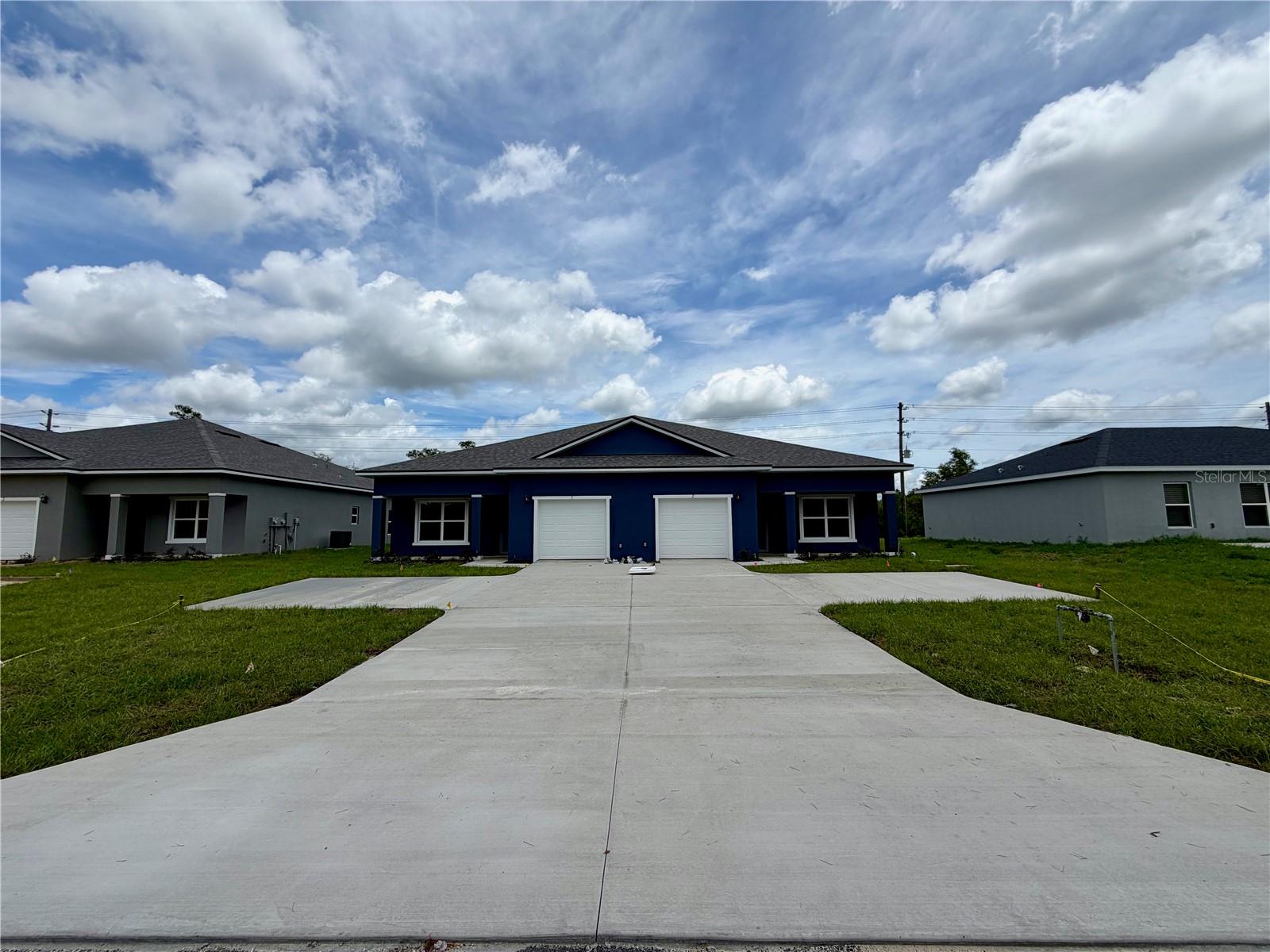 Exceptional opportunity to purchase a brand new concrete block construction duplex with each unit consisting of 3 bedrooms 2 bathrooms with a 1 car garage in a central location close to everything Marion Oaks and Ocala has to offer. This isn’t your run-of-the-mill duplex all high-end finishes including luxury vinyl planking throughout, Sparkling White Quartz countertops, 42” Upper cabinets, full stainless steel appliance package, beautifully designer bathrooms with floor to ceiling tile, private indoor laundry closet with washer & dryer set included, as well as a covered private rear lanai. Master bedroom is well sized and features his & hers walk in closets, dual sink vanity, and walk-in shower. The open concept floor plan with the living room dining room and kitchen all flowing together perfectly. Both guest bedrooms are well sized and have ample closet space. Not to mention this is a rare opportunity to have the units on city water and sewer! Don’t let this chance pass you by call today for more information and schedule your private tour!