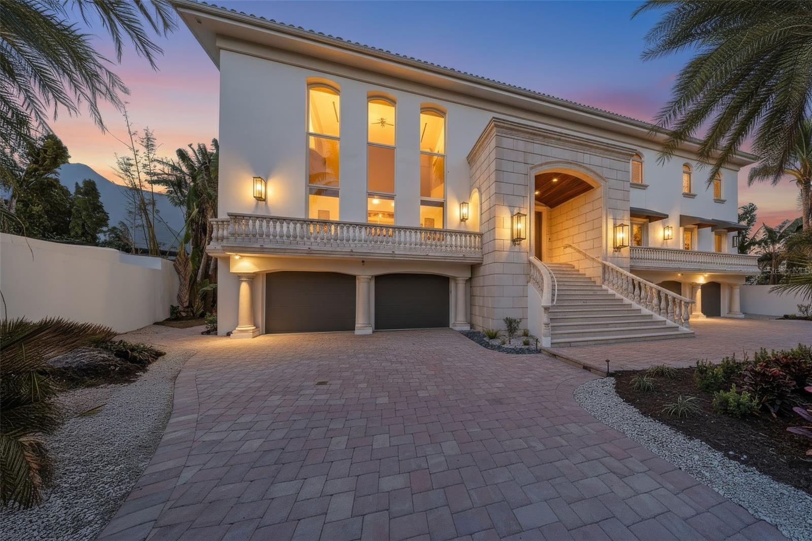 Discover waterfront living on the coveted north end of Siesta Key. Set along South Coconut Bay with access to Roberts Bay and the Intracoastal Waterway, this sprawling estate offers exceptional privacy, water views, and over 7,000 square feet of refined living space.

Soaring ceilings and walls of glass fill the home with natural light, while the open-concept layout and contemporary design create an ideal setting for both everyday living and entertaining. A cylindrical glass elevator serves as a subtle architectural feature within the home’s modern design.

The gourmet kitchen is appointed with custom cabinetry, premium appliances, and Sub-Zero refrigeration, complemented by a built-in coffee system, 140-bottle wine cooler, and an oversized island designed for gathering. Multiple fireplaces add warmth throughout the home, while the private home theater with refreshment bar offers an elevated entertainment experience.

Outdoor living includes expansive terraces, an infinity-edge pool and spa, and peaceful bayfront surroundings. The primary suite features a private waterfront terrace, fireplace, sitting area, dual walk-in closets, and morning bar.

Built with reinforced concrete construction and Anderson hurricane casement windows, the home blends luxury with durability. Additional highlights include a 10-car garage, gym, office, and generously sized guest accommodations. Meticulously maintained, the home also features a freshly painted exterior.

A rare opportunity on one of Siesta Key’s most sought-after streets.
