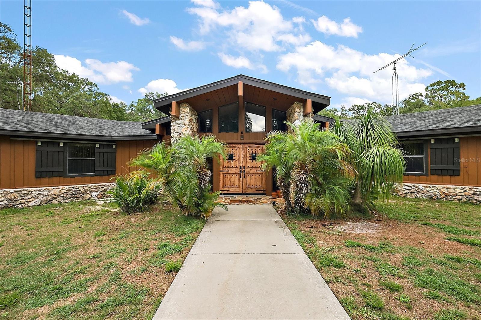 Check out this amazing 4 Bedroom 2 ½ Bath Home, LARGE POOL, BEAUTIFUL STONE FIREPLACE, RV HOOK UP and STORAGE, Hot Tub, a large 2-car garage, the detached garage will allow for an additional 4 or more cars to be parked, on 3.15 acres with RV 50 Amp hookup and 18 x36 RV Storage Shed, 20x45 Workshop is equipped with electricity directly connected is an additional 18 x 28 Storage Shed. This home’s exterior paint has been updated in 2025). You will enter the home through a beautiful double door entryway, into the family room, where the stonework of the fireplace wraps you up into a cozy place where you will enjoy entertainment each evening. The kitchen boasts ample cabinets for storage, a large eat-in kitchen, and a separate dining room. The large utility room is adjoining the kitchen area. The 4th bedroom is currently used as a media room. You will enjoy a bit of paradise as you walk out to the covered back porch. Now you're ready to enjoy the great outdoors, with a large outdoor cooking area, and the pool is 10 feet deep with a large pool deck that is ready for entertaining family and guests. As you enter this property, you immediately feel at home with the beautiful oaks that line the drive with a gated entry and a fence perimeter. This property features mature oaks, 30 avocado trees non-producing as of yet, and loquat trees. This location is prime for privacy, yet only minutes from Walmart and Wawa. A splash pad park at Twisted Turtle Splash Resort is opening in the summer of 2026. Kenny Dixon Sports Complex for all your outdoor sporting activities. The Dade State Park is where all the festivals come together, and the County Fair is just a few minutes away. The Tampa International/Tampa/Orlando area is all within an hour. The Villages are also a short distance away with more restaurants and shopping options. And for those adventurous ATV riders, Croom is a short distance as well. This home truly has it all, a solid home that will protect your family, keeping everyone safe and secure while enjoying this unique lifestyle home if you're a homebody and looking for a quiet, serene lifestyle, or love having the family and friends over for all the Holidays and entertaining! Call today for your private showing!!