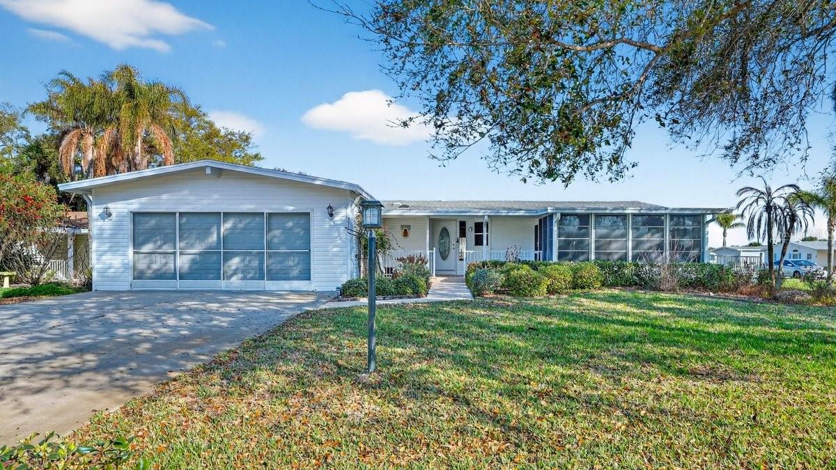 This well-maintained three-bedroom, two-bathroom manufactured home with a two-car garage is located in the beautiful community of Lighthouse Cove. The home features an open floor plan with abundant natural light, creating a bright and welcoming living space. The spacious kitchen and living areas flow nicely together, making it ideal for both everyday living and entertaining. The primary suite includes a double-vanity sink, walk-in shower, and a relaxing garden tub with Jacuzzi. Additional highlights include tile and carpet flooring, an inside laundry room, and a two-car garage. Enjoy outdoor living with a screened-in lanai, a covered front porch, and a spacious lot offering plenty of room to relax. Residents of Lighthouse Cove also enjoy wonderful community amenities including a pool, pickleball courts, shuffleboard, and a convenient boat launch.