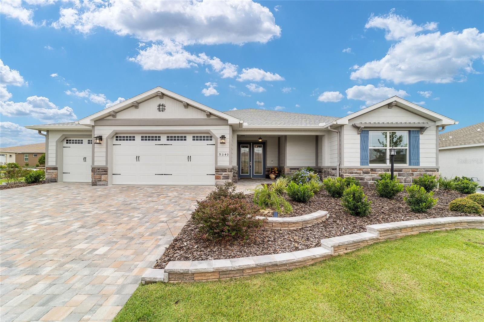 Location, location, location! This immaculate estate home is located on an oversized corner lot near THE LODGE in Kestrel at Candler Hills. This Wellington model is a split wing home with 3 bedrooms, 3 bathrooms, 2 flex rooms, and a 3-car garage. This home features two owner bedrooms with walk-in closets and en suite bathrooms with walk-in showers and frameless shower enclosures. This open concept home has an oversized island that separates the kitchen from the great room which makes for easy entertaining. The gourmet kitchen is a chef’s delight with staggered cabinetry, under cabinet lighting, quartz counter tops, glass tile back splash, stainless steel gas cooktop, built-in stainless-steel oven and microwave combo, and huge walk-in pantry. Upgraded ceramic tile set on the diagonal is throughout meaning no carpet. This home has two separate flex spaces that can serve a multitude of functions including craft room, office, TV room, or dining room.  The flex room off of the kitchen features a custom built-in with sine cabinet and mini fridge, perfect for entertaining.  Finishing touches include an owner's private entry from the garage, ray ceilings, and crown molding throughout.  The extended screened lanai offers semi-private views of a non-buildable green space.  The curb appeal is spectacular with upgraded landscaping, brick paver driveway, stone elevation, and so much more! Enjoy resort living at its finest in this luxurious home with all of the exclusive Candler Hills amenities, curbside trash and recycling, and curbside mail.  Located in Ocala's premier, gated, active 55+ community, loaded with amenities, including golf cart access to three shopping centers and the square.  Golf cart and furniture are available for purchase outside the sale of the home.