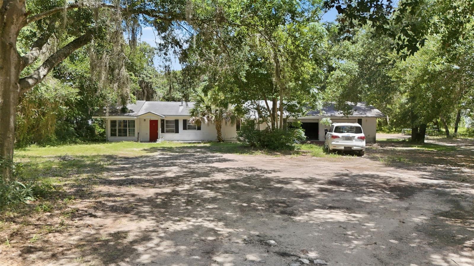 Exceptional 2.5± acre development opportunity in the heart of Eustis! Located on E. Washington Avenue, this rare parcel offers outstanding potential for residential development or redevelopment in a rapidly growing area. The property is currently improved with an existing 3-bedroom, 2-bath home that is tenant occupied, providing interim income while future plans are developed. Mature oak trees create a picturesque setting, and the generous acreage offers flexibility for a variety of potential uses, subject to local zoning and approvals. Conveniently located near shopping, dining, schools, medical facilities, and downtown Eustis with easy access to Mount Dora, Tavares, and major roadways. Whether you're a builder, developer, or investor looking to secure a prime land holding, this is an opportunity you won't want to miss.