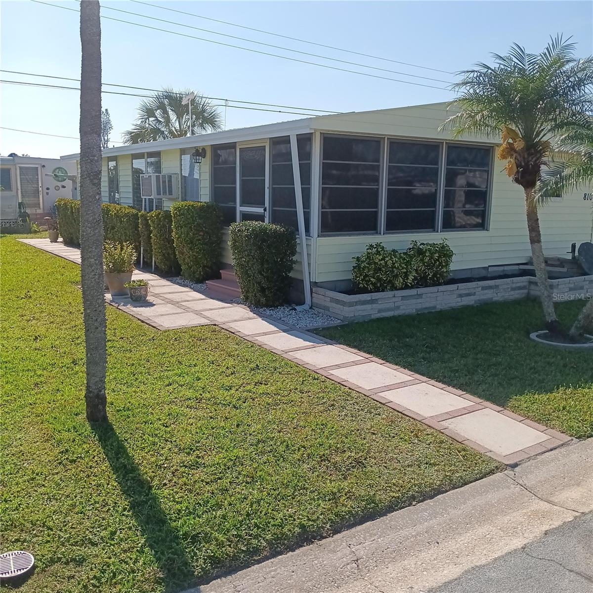 Come and see one of the most affordable “Non Age Restricted”, “Land Owned” homes in Bradenton Florida, home is newly updated and impeccably clean. You won’t have to lift a finger just bring belongings and move right in. Home is located in the Fair Lane Acres community which is Land Owned with low maintenance fee of only $134 water, sewer cost inclusive. Park has amenities featuring, swimming pool, shuffle board and pickle ball court as well as large clubhouse with many activities.Home features 2 Bedrooms, 2 bath with new tub and surround, newly remodeled kitchen with separate dining area, beautiful lania and large living room area.  Ample storage with 2 storage areas attached to a 2 car carport. All newer appliances will be included: Washer, Dryer, Refrigerator and Stove. A special feature of this home is the brick and concrete rap around sidewalk leading to front entry, then continuing to a beautifully landscaped patio with palm trees and a real Florida feel for entertaining. Great location with a multitude of shopping, restaurants, and entertainment nearby. You are only 6 miles from SRQ airport, 8 miles to beautiful beaches and Anna Maria Island, a quick 10 miles gets you to to downtown Sarasota.A convenient and affordable option for those seeking a relaxed Florida lifestyle.Schedule a visit today to see this special place.
