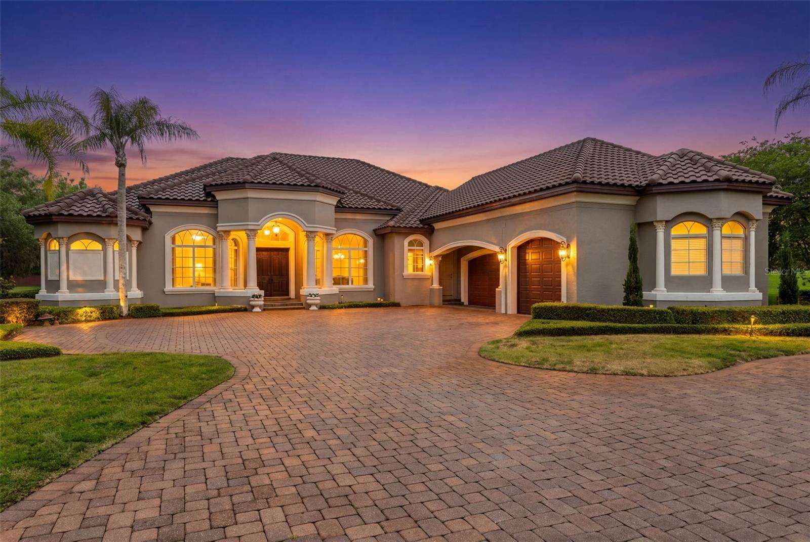 One or more photo(s) has been virtually staged. Welcome to this stunning custom-built estate nestled on an oversized lot with serene pond views inside a gated and guarded community. This spacious home was thoughtfully designed with both everyday living and entertaining in mind, offering a versatile floor plan, incredible storage, and beautiful indoor-outdoor living spaces.

Step through the grand entryway into the formal living and dining areas, complete with a cozy fireplace and elegant architectural details throughout. The private office features custom shelving, while the expansive primary suite offers tray ceilings, a sitting area, dual walk-in closets, and a luxurious ensuite bath with a whirlpool tub, oversized shower, and dual vanities.

The gourmet kitchen is truly the heart of the home, featuring Monogram appliances, a gas cooktop, double ovens, an oversized pantry, butler’s pantry, additional prep sink, and an open layout overlooking the family room and dinette area. The thoughtfully designed three-way split bedroom layout provides privacy and functionality for family and guests alike.

Enjoy endless entertainment possibilities with a huge game room, upstairs bonus/media room with half bath, and multiple storage areas throughout the home. The upstairs space is finished with A/C and hardwired connections, making it ideal for a media room, home gym, playroom, or flex space.

Step outside to your private backyard retreat featuring a corner pool, spacious lanai, four sets of sliding doors, and an expansive yard overlooking the spring-fed pond filled with incredible wildlife, including otters and unique whistling ducks. The property also offers a garden area, French drain system to the lake, and direct neighborhood trail access.

Additional highlights include 8-foot doors throughout, a large laundry room with sink and cabinetry, pool bath access, oversized storage room, and a 3-bay garage with high-bay access perfect for additional vehicles, boats, or storage.

This one-of-a-kind property offers the perfect blend of luxury, privacy, and functionality — ready for its next family to call it home.