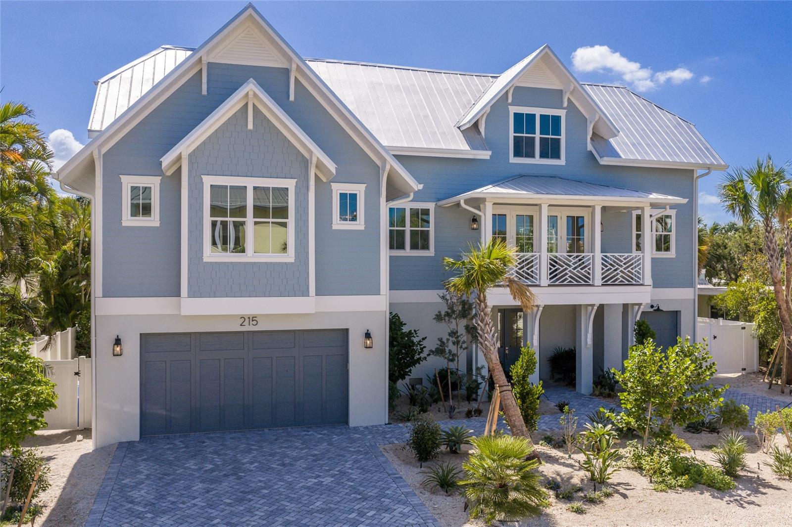 Welcome to a rare offering on the coveted north end of Anna Maria Island — a brand-new coastal sanctuary where architectural sophistication meets the timeless charm of Old Florida. Ideally positioned just steps from the sugar-white sands of the Gulf and moments from the boutique shops, galleries, and countless dining options of historic Pine Avenue and the surrounding area, this exceptional 4-bedroom, 4.5-bath residence captures the essence of elevated island living — and sits within one of the island’s most desirable short-term rental zones.
Designed with a refined, light-filled aesthetic, the home welcomes you with wide-plank hardwood flooring and a seamless flow between spaces that feel at once elegant and effortless. At the heart of the main level, a designer kitchen serves as the showpiece — outfitted with custom cabinetry, a generous island with seating, premium appliances, a dedicated wet bar, and a fully appointed butler’s pantry that makes entertaining feel second nature. Multiple gathering areas, including a secondary upstairs family room, offer a thoughtful balance of togetherness and retreat.
The primary suite is a private sanctuary of understated luxury, anchored by a spa-inspired bath with a sculptural soaking tub, oversized walk-in shower, and bespoke designer finishes. Three of the four bedrooms enjoy their own private ensuites, and every bedroom features a walk-in closet — a refined blend of privacy and comfort for family and guests alike.
Step outside to a fully screened ground-level living area that functions as a true extension of the home, complete grilling area and lounge designed for year-round enjoyment. Beyond, a private tropical oasis unfolds around a sparkling pool with integrated spa and a gas firepit framed by lush landscaping and a vinyl privacy fence that creates a secluded, resort-caliber setting for gathering or quiet escape.
Every detail has been considered for ease and longevity, including Lutron lighting controls, three-zone climate systems, a metal roof, outdoor shower, and a three-car garage. Offered fully furnished, the property is delivered as a true move in ready opportunity.
Beyond the walls of the home lies the magic of the north end — the most coveted and character-rich stretch of Anna Maria Island, known for its pristine beaches, the legendary white sands of Bean Point where the Gulf meets Tampa Bay and the walkable, tree-lined corridor of Pine Avenue with its celebrated restaurants, cottage shops, and cafés. Days begin with sunrise strolls along the shore and end with sunset dinners just minutes from your front door.
With short-term rentals permitted, unmatched walkability to both the beach and Pine Avenue, and a rare combination of design, location, and lifestyle, this residence represents one of the most compelling offerings on Anna Maria Island — a legacy property with exceptional income potential in Florida’s most storied coastal village.