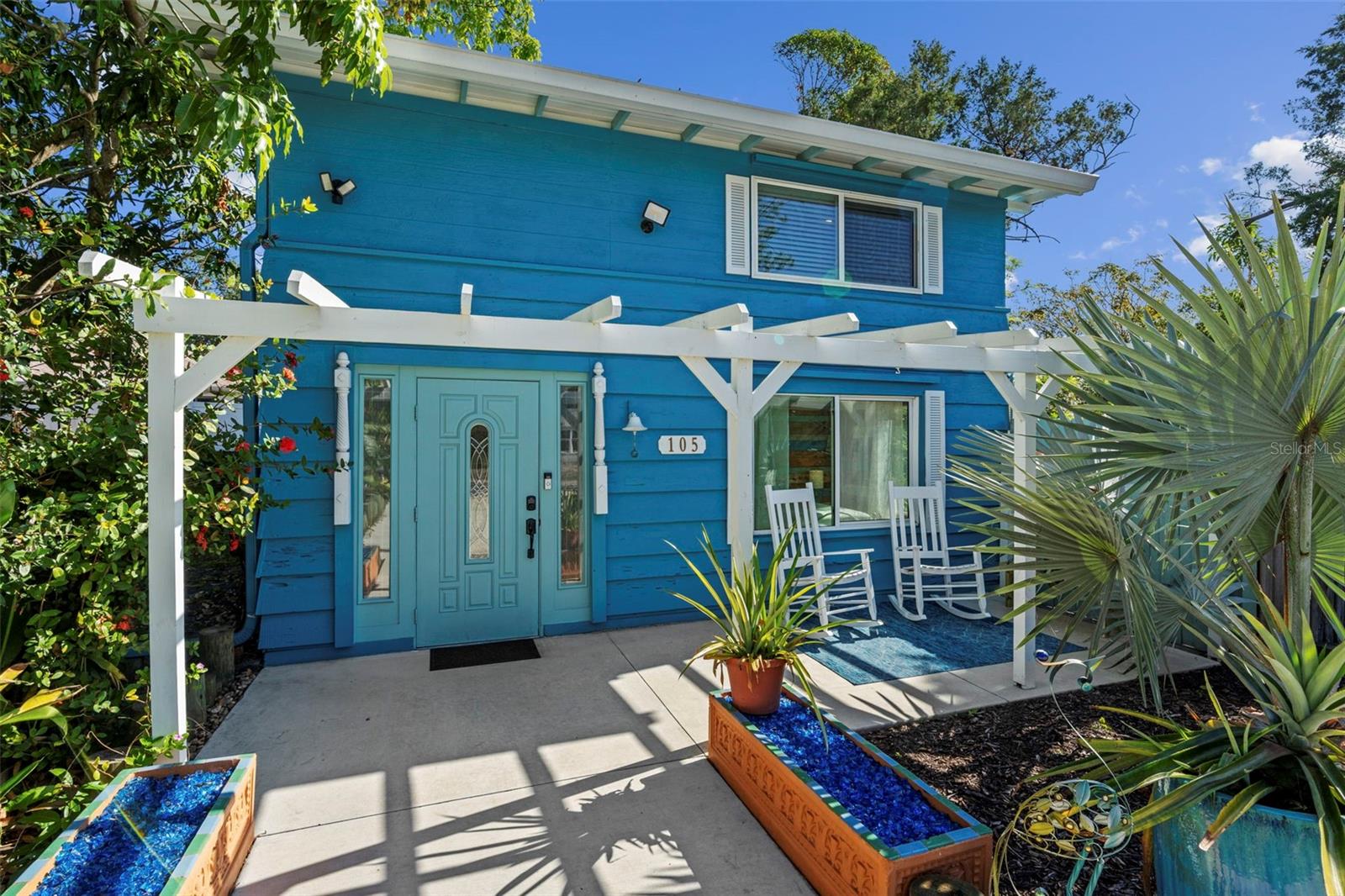 A rare opportunity to acquire a beautifully restored 1940 coastal-inspired Key West style Florida bungalow positioned on an oversized 0.38-acre parcel offering future subdivision potential. Following closing, the property may be split into three separate lots, creating one residence lot with the existing home, and two additional buildable parcels—an exceptional value-add opportunity in a highly desirable Sarasota location.

The 3-bedroom, 1.5-bath residence blends architectural character with curated modern upgrades. Interior highlights include refinished bamboo and wood flooring, exposed wood ceiling beams, and custom cedar built-ins that enhance the home’s refined coastal Key West bungalow aesthetic. The chef’s kitchen is thoughtfully designed with solid wood cabinetry, quartz countertops, an imported Italian tile backsplash, and updated stainless steel appliances. An adjacent addition provides expanded pantry storage and a laundry area, leading to a spa-inspired primary bathroom featuring dual vanities, a freestanding soaking tub, and a walk-in rain shower.

The upper level hosts a private primary suite with a generous walk-in closet with built-ins, a second bedroom, and an updated half bath, while the third bedroom is conveniently located on the main level—ideal for guest accommodations or flexible use.

Outdoor living has been elevated to an almost resort-style experience, featuring a 12-foot above-ground pool/spa with custom wood decking, multiple patios finished with imported Italian crystal tile, and a lush botanical setting with over 200 plantings and mature fruit trees including banana, mango, avocado, peach, and guava. Additional amenities include a pavilion, private outdoor shower, and a firepit designed for elevated entertaining and relaxation.

Significant capital improvements include a 2023 metal roof, hurricane-rated windows, 2021 HVAC system, 2022 water heater, recent connection to public water, and a 2024 well pump with filtration system also on property. The home offers insulated and drywalled interiors, newly installed wheelchair-accessible outdoor walkway paths, an extended 6+ vehicle driveway, and a 12x14 detached workshop or garage, further enhancing functional versatility.

With no HOA, no deed restrictions, and no flood insurance required, this property presents an exceptional combination of lifestyle appeal and long-term investment flexibility. Ideally located just minutes from downtown Sarasota’s premier dining, shopping, and cultural attractions, this offering is well-suited for private ownership, redevelopment, or strategic portfolio expansion.
