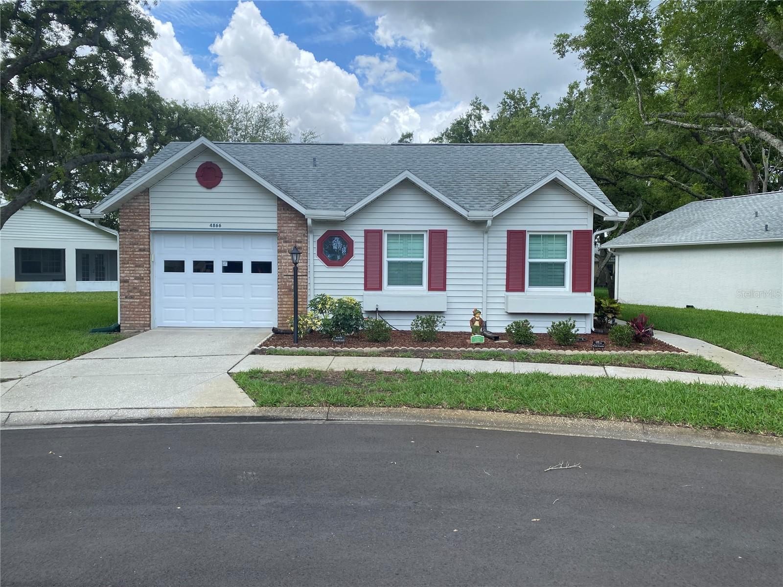 Beautiful stand-alone condo located in the equally beautiful and popular 55+ community of Heritage Lakes. This 2-bedroom, 2-bathroom 1 car garage home is well maintained and ready for a new homeowner. Enter the home into your open Livingroom and dining room combo space with vaulted ceilings and plenty of natural light. Kitchen includes all major appliances and has plenty of granite counter space and room for a dinette. Primary bedroom is good sized features an on-suite bathroom and walk in closet. This home also features a great little enclosed sunroom area for your morning coffee.  This community is located close to everything in the Trinity area including shopping and  dining establishments and with easy access to HWY 589 leading to TIA. There is a clubhouse with many activities, clubs, and dances. You will have access to the community pool, tennis, pickle ball and shuffleboard courts. This community is maintenance free including lawn care, house painting, exterior pest control, and irrigation repairs. Roof replaced in 2022, new hurricane windows and sliding door in 2023. Enjoy the good life of condo living with a free standing home.