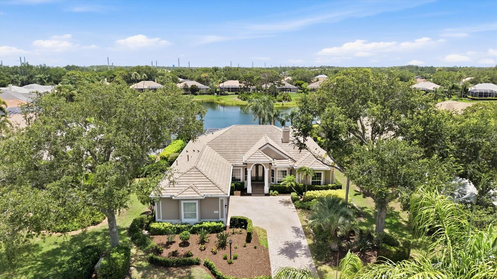 Fall in love with this completely renovated luxury residence in the prestigious University Park Country Club, offering breathtaking lake views and resort-style living at its finest. From the moment you step inside, you will be captivated by the sparkling waters of the oversized pool and spa, beautifully showcased through the grand front entry and overlooking the tranquil lake beyond. The impressive foyer opens into a spacious great room featuring a stunning floor-to-ceiling fireplace and an open-concept design ideal for elegant entertaining and everyday living.

The designer kitchen is a true masterpiece, showcasing custom-crafted cabinetry, premium Thermador appliances, an oversized center island, a dedicated coffee station, and a spacious walk-in pantry designed for exceptional storage and organization.

Designed with comfort and privacy in mind, this split-bedroom floor plan offers a luxurious primary suite on one side of the home, while two additional bedrooms, a private office, and a media room are thoughtfully situated on the opposite wing. 

The expansive outdoor living area is destined to become your private retreat for relaxation and entertainment, complete with generous covered spaces surrounding the spectacular pool and spa. Completing this exceptional property is an oversized three-car garage — always a highly desirable feature in a luxury home.

EXPERIENCE The University Park With its mature landscape and sprawling natural beauty, University Park is the premier master-planned community in the Sarasota area. Behind the secured, staffed entrance is an award-winning, resident-owned community featuring 27 holes of four-star rated golf, eleven lighted Har-Tu tennis courts, four pickleball courts, a fitness center, croquet, miles of tree-lined streets for walking or biking, and first-class dining. Also offered are numerous social activities and many social clubs designed to fit a variety of interests. Located only four miles from downtown Sarasota and its spirited arts community, museums, shopping, dining, and first-class healthcare, University Park is an oasis from the City but close enough to all amenities. It's only a short 15-minute drive to some of America's finest beaches, superb outdoor recreation areas, including the internationally renowned Nathan Benderson Park, the famed Ringling Museum, various boating options, and the acclaimed St. Armands Circle. University Park's breathtaking beauty is unmatched by any other.

Designed with comfort and privacy in mind, this split-bedroom floor plan offers a luxurious primary suite on one side of the home, while two additional bedrooms, a private office, and a media room are thoughtfully situated on the opposite wing. The expansive outdoor living area is destined to become your private retreat for relaxation and entertainment, complete with generous covered spaces surrounding the spectacular pool and spa. Completing this exceptional property is an oversized three-car garage — always a highly desirable feature in a luxury home.