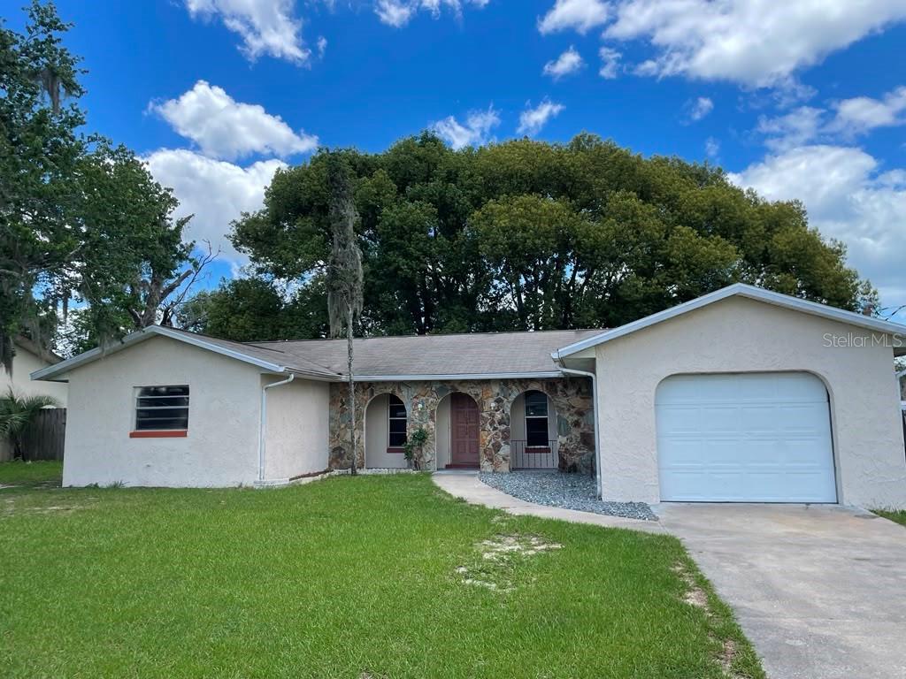 Opportunity awaits in this 3-bedroom, 2-bath home with 1,670 square feet in the heart of Belleview. Featuring a spacious living room, screened porch, new luxury vinyl flooring in the main areas, and brand-new carpet in the bedrooms, plus fresh interior paint. Matured tree backyard offers shade and privacy, along with a convenient storage shed. This home is ready for your personal updates—ideal for homeowners or investors looking to add value. Prime location just minutes from Lake Lillian Park and Highway 301, with easy access to schools, shopping, dining, and medical facilities.