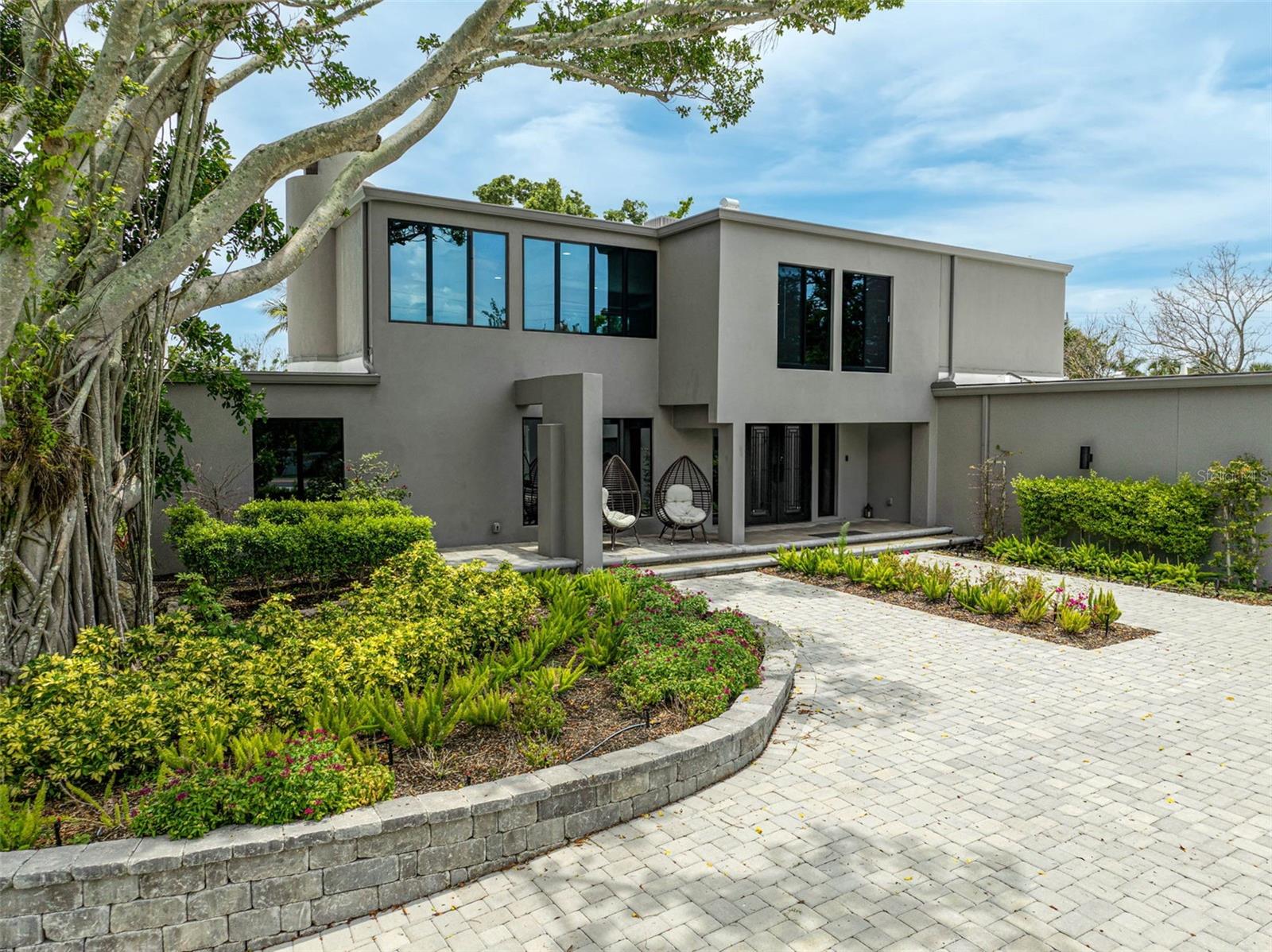 Elevated Living. Expanded Luxury. Move-In Ready.

More space. More land. More peace of mind — and better value than new construction.
This rare Siesta Key estate offers twice the living space and double the lot size of typical new construction homes on the Key, while sitting high and dry on an above-flood-level lot. No construction delays. No compromises.


Designer Waterfront Living on Treasure Boat Way – Rare Value Meets Lasting Style
Modern Waterfront Estate on Siesta Key | 512 Treasure Boat Way

Perfectly situated on a spacious .44-acre corner lot in one of Siesta Key’s most sought-after boating communities, this fully renovated modern estate offers over 5,000 square feet of sophisticated living. With 4 bedrooms, 4.5 bathrooms, and a dedicated media room, the layout is both functional and refined.

Enjoy deep-water dockage on a wide canal and direct access to Sarasota Bay—ideal for boaters looking to explore the Gulf of Mexico with ease. The home’s high flood elevation and no history of flooding provide peace of mind and lower insurance premiums, adding even more value to this exceptional property.

Inside, dramatic design meets everyday comfort. Step through the doors to find soaring ceilings, a custom open-tread staircase with walnut treads, and a striking stone feature wall. Walls of glass flood the interiors with natural light, highlighting European porcelain flooring, designer lighting, and a double-sided fireplace that anchors the open living spaces.

The gourmet kitchen is a showstopper—designed for both entertaining and daily living—outfitted with quartz countertops, flat-panel cabinetry, floating shelves, and a full suite of premium appliances. The luxurious primary suite includes private pool access and a spa-inspired bathroom with a freestanding soaking tub, dual vanities, and bespoke tilework.

The dedicated media room features sliding glass doors that open to a private courtyard, offering a quiet, flexible space ideal for movie nights or casual relaxation.

Treasure Boat Way has been thoughtfully renovated to preserve its original mid-century style while modernizing with sleek industrial touches. The result is a home that is sophisticated, private, and relaxing.

Outside, tropical landscaping and an expansive backyard set the tone for true waterfront living. Multiple lounge areas and seamless indoor-outdoor flow make this a perfect setting for entertaining or unwinding, with captivating water views from nearly every room.

Whether you’re searching for a primary residence, a vacation retreat, or an income-generating investment, 512 Treasure Boat Way checks every box—offering modern updates, premium waterfront access, and a short stroll to Siesta Key Village and Siesta Beach.

This property offers strong appeal for both investors and owner-occupants. With excellent potential for short-term rental income and a layout designed for comfort and privacy, it’s equally suited for generating revenue or providing a welcoming home for a family.
Schedule your private showing today to experience the pinnacle of luxury waterfront living. **No flood damage**