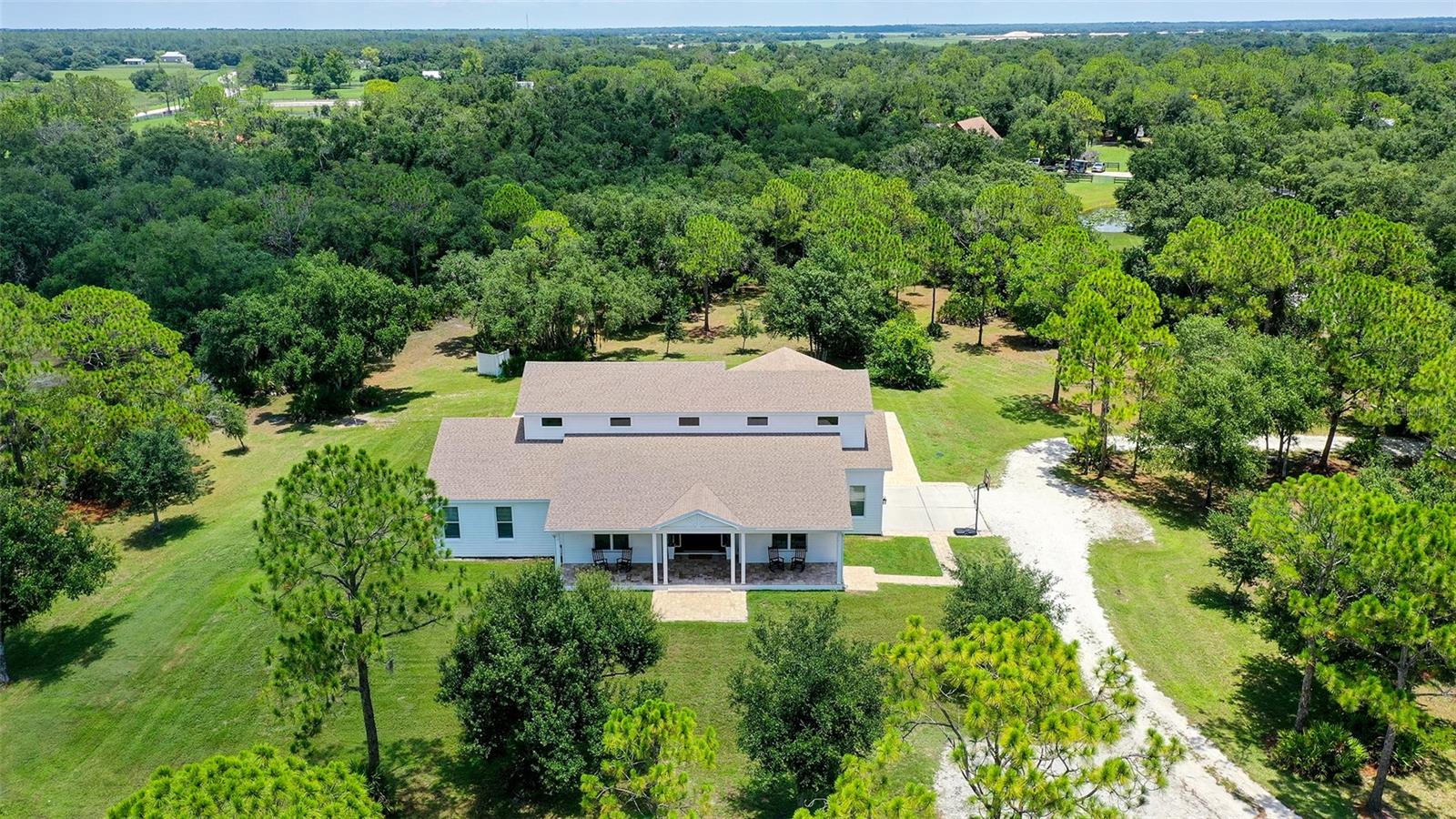 This is over FIVE ACRES in one of Sarasota's most PRIVATE communities, where seeing deer in your backyard is normal, the only traffic you'll hear is birds, and you can finally enjoy the kind of quiet that's becoming incredibly hard to find. Even though it feels like you're miles away from everything, you're less than 15 minutes from groceries and restaurants around Lakewood Ranch, about 25 minutes from downtown Sarasota, and roughly 30 minutes from Siesta Key Beach. You really don't have to choose between CONVENIENCE and PRIVACY anymore.

Inside, the home is just over 4,000 square feet with FOUR bedrooms, FOUR bathrooms, plus BONUS room and LOFT space, soaring ceilings, and an open floor plan that was designed for both everyday living and entertaining. The chef's kitchen flows into the great room, while the covered lanai and saltwater pool become an extension of the living space. This home was CUSTOM built in 2016 with hurricane resilience in mind. It features IMPACT windows and doors throughout, a whole-house GENERATOR, and it's about 42' elevated and NOT in a flood zone. When everyone else is worrying about storms, this is the kind of home designed to help you feel prepared.

You're just minutes from Lakewood Ranch, but without the high HOA and CDD fees or the cookie-cutter neighborhoods where the view out your window is the side of your neighbor's house. Here there's room to throw the ball, have a garden, or play in the treehouse.
Sitting on more than FIVE ACRES, you have room to dream. Add a barn, create a homestead, bring horses, build another structure, or simply leave it exactly as it is and enjoy the PRIVACY that comes with owning this much land. The garage is 2 car plus a 10' extension where you can store your bikes, 4 wheelers, and more. Nestled within The Ranches at Bern Creek neighborhood which has all properties 5-10 acres in size, you will always maintain your peace, even when new development starts filling in around the area.

Finding a beautiful custom home with acreage and just a short drive to Lakewood Ranch, downtown, and the beaches—with this level of privacy, hurricane preparedness, low HOA fees, and a location that's still convenient to everything Sarasota has to offer—is incredibly rare.