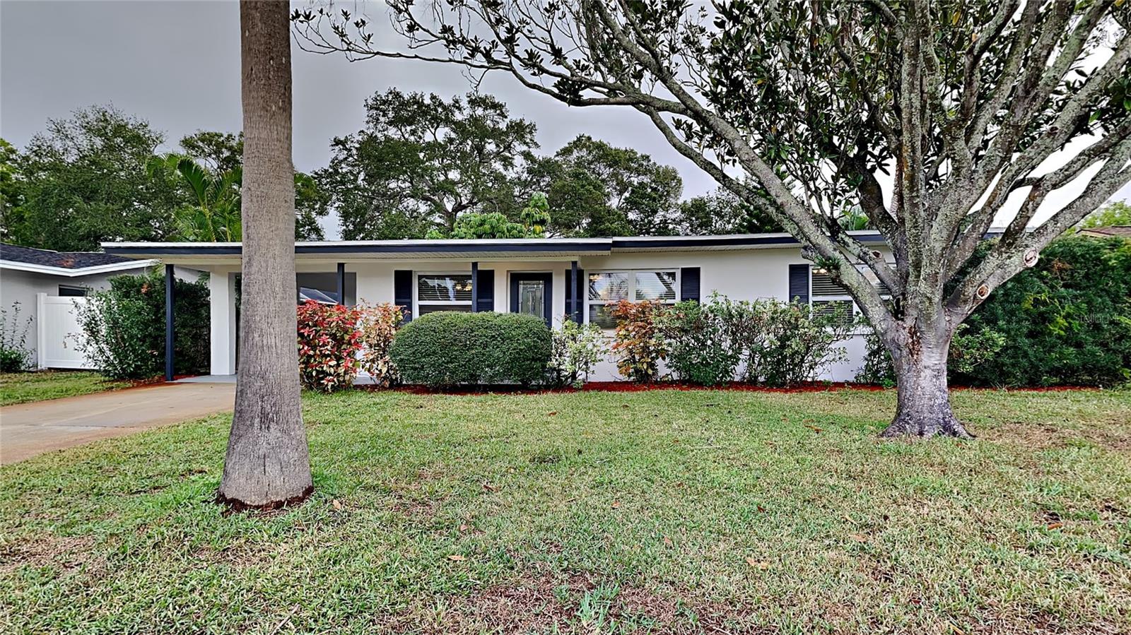 Move in ready! This 2 bedroom, 1.5 bathroom home is located in Indian Rocks Highlands! As you walk through the front door you will notice that the home has new interior paint, tile flooring, a modern kitchen, modern bath and so much more. The kitchen boasts modern cabinetry, granite countertops, stainless steel range, microwave, dishwasher, and refrigerator. The open living and dining room area is a perfect space to entertain family and guests. New carpet in both bedrooms. Relax out back on the deck overlooking your large, fenced backyard with plenty of room for a pool. Located close to Gulf Beaches, shopping, and dining. HVAC 2016, Roof 2023, Water heater 2021. Schedule your showing today!
