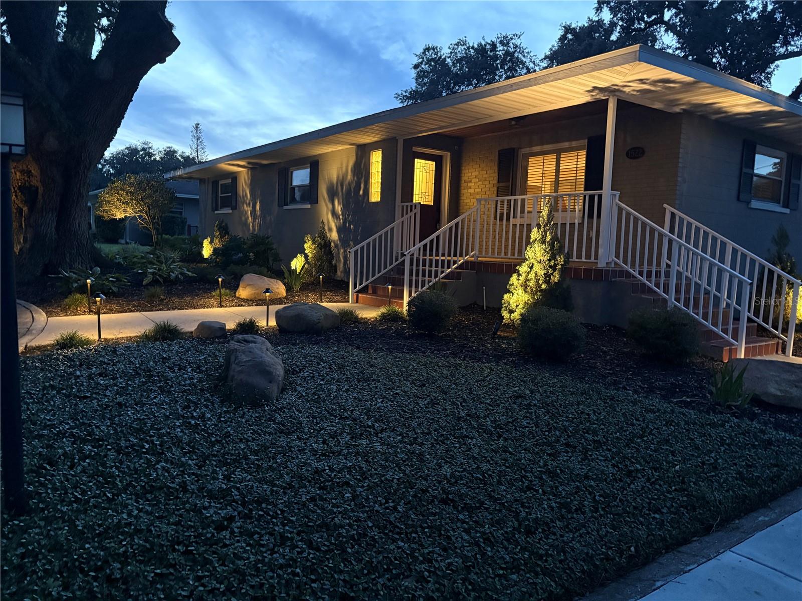 Welcome Home to the Florida Lifestyle in this Mid-Century 3BR/2.5BA home. Perfectly positioned near the Polk Parkway, you have easy access to I-4 for commutes to Tampa or Orlando. You will be steps away from Lakeland's Three Parks Trail that takes you to Lake Hollingsworth and a short drive to downtown Lakeland, where you'll enjoy premier dining, boutique shopping, and scenic parks. With no HOA, this property offers added freedom and flexibility. The Owners of this home have created an exceptional blend of timeless elegance and modern comfort within its 2,220 S.F. of living area. As you enter the home, the beauty of the original oak floors greets you in the formal living room. Continue to the separate dining room and on to the spacious family room, all with hardwood floors. There's crown molding throughout the home. The remodeled kitchen has porcelain tile flooring in a herringbone pattern, quartz countertops, and solid wood cabinets. A 5-burner gas range and stainless steel appliances give the family's cooks everything they need. There's plenty of storage in the kitchen, including a large pantry. The hall bath was updated with granite countertops and built-ins in the shower/tub. The large second bedroom is unique with original built-ins. Make the 18' x 15' primary bedroom your own retreat and enjoy the tastefully remodeled bath that has a walk-in shower and a vanity with quartz surfaces. There's a third bedroom for guests or for the family. The two car garage is an extension of the living space with a half bath, epoxy flooring, a mini-split air conditioner/heater, and a large screen TV. Outside from the kitchen is a patio with pavers that creates a great space for gatherings. A new roof was installed in 2021. New AC compressor, air handler, and AC ducting, and new AC vents installed in 2024. All new windows and doors installed in 2020. Numerous additional upgrades/renovations have also been accomplished by the owners, and a list can be provided upon request. The front of the home features a circular drive and professionally installed exterior lighting to show off the new landscaped front and side of the yard. Schedule your private tour today to experience this remarkable home first hand. Home is being sold "AS IS" for the convenience of the Sellers. Buyer and Buyer's agent to verify all information, including room sizes, schools, and zoning.