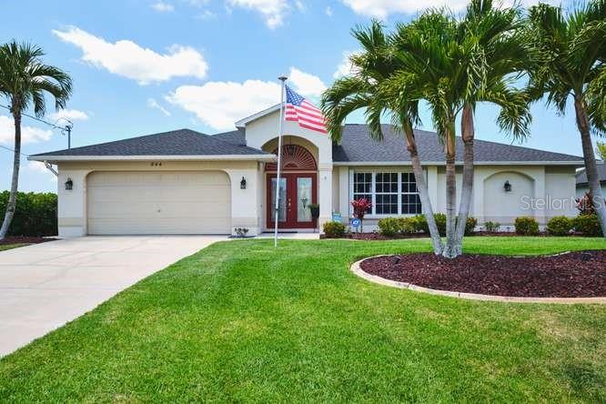 Assumable 2.812% loan available to qualified buyers—an exceptional opportunity in today’s market. This 3 bedroom plus den, 2 bathroom home is high and dry with no flood insurance required and no history of water intrusion, offering true peace of mind. Enjoy coveted western rear exposure overlooking a freshwater canal with seawall, just moments from Arrowhead Lake, complete with a private dock. All assessments are in, and the home is equipped with solar panels for a predictable electric bill. Storm-ready and thoughtfully upgraded, the property includes a Generlink hookup with a 10,000-watt portable generator, motorized Kevlar storm shutters, and accordian/manual shutters for windows. Additional updates include a 2022 roof, brand-new water heater, upgraded appliances, alarm system, and Caloosa privacy hedges for added seclusion. From the moment you arrive, the pride of ownership is unmistakable. Lush, manicured landscaping, vibrant green grass, and mature plantings create outstanding curb appeal and a welcoming first impression. Inside, the home continues to impress with its meticulous care and organization. The spacious layout is designed for both comfort and entertaining, featuring generously sized rooms, vaulted ceilings, and abundant natural light throughout. Both bathrooms have been updated with neutral fixtures, offering a clean and timeless feel. The 2-car garage includes a new refrigerator/freezer and deep freezer, adding convenience and storage. The kitchen is a standout, ideal for any home chef, with solid wood cabinetry, neutral granite countertops, upgraded stainless steel appliances, and a reverse osmosis system for drinking water. This property is offered furnished for ease and convenience, showcasing thoughtfully selected, well-designed furnishings that complement the home’s style and make it truly move-in ready. Step outside to your screened lanai, complete with no-see-um screens and hurricane straps, creating the perfect space to relax or entertain while enjoying the peaceful waterfront setting.