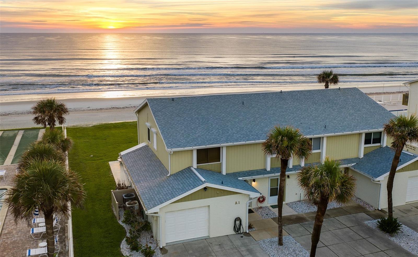 Refined, income-producing, and positioned along one of the most tightly held stretches of no-drive beach, this exceptional end-unit beachfront townhome is a rare offering in a market where properties of this type seldom become available. It delivers coastal luxury without compromise, blending privacy, lifestyle, and strong rental performance in one cohesive asset. Located directly on the highly sought after no-drive beach, the residence offers a seamless connection to sand, surf, and open coastal space. Featuring 2 bedrooms, 3 bathrooms, and an expansive grassy beachfront yard, it provides a setting that is increasingly difficult to find in today’s market. Thoughtfully designed with both comfort and sophistication in mind, the interior showcases a well-appointed kitchen featuring premium Bosch appliances, while the living room is enhanced by electronic shades that elevate both convenience and ambiance. Each bedroom is designed as a private en-suite retreat, while a convenient half bath downstairs enhances comfort for guests and entertaining. The primary suite opens to a private beachfront balcony overlooking the Atlantic. The primary bathroom features a spacious walk-in shower and modern fixtures, creating a true seaside retreat. The guest suite is thoughtfully designed to accommodate family and guests alike, featuring a queen bed, custom matrix bunkbeds, and a private en-suite bathroom complete with a shower/tub combination. With strong rental performance and a direct beachfront position, this property offers the rare opportunity to own a coastal residence that lives beautifully while performing as a high quality income-producing asset.