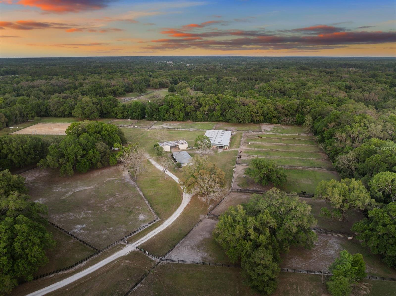 Rare opportunity to acquire a true large scale equestrian property in the heart of Newberry and Jonesville. Situated on 37 acres in highly desirable Marlboro Farms, this 40 stall facility offers a level of infrastructure, functionality, and location that is increasingly difficult to find in Alachua County, approximately 45 minutes from the World Equestrian Center.

At the center of the property is a substantial concrete block barn with metal roof and truss construction, built for durability, safety, and long term use. The barn includes 40 stalls, automatic waterers, multiple tack and feed rooms, a fly system, six wash racks including one with hot water, and an efficient layout designed for daily operation.

The property features 17 irrigated paddocks with automatic waterers, providing consistent grass and allowing for year round rotation. Additional equestrian improvements include a 150 x 250 irrigated arena with footing, a grass jump field, and an 80 foot round pen with observation deck.

A 3,000 square foot metal equipment building with approximately 25 foot ceilings provides substantial storage and operational support.

The residential component includes a duplex totaling approximately 2,700 square feet, with a 3 bedroom 1 bath unit and a 1 bedroom 1 bath unit, along with a separate office and bathroom. This allows for staff housing, rental income, or on site management, with the option to build a custom primary residence.

Located less than a mile from Publix, Tractor Supply, and restaurants, and just minutes to the Town of Tioga, UF, and Santa Fe College, this property is a rare combination of scale, convenience, and usability within a rapidly growing area.

In addition to its current use as a working equestrian facility, the property offers long term flexibility. With the existing plat, there may be potential for additional homesites, subject to county approval, creating further opportunity for future use or investment.

Large properties of this scale and capability are rare in this location. This offering presents an opportunity for a trainer, investor, or owner occupant to operate an income producing equestrian business, create a private estate, or capitalize on future potential. Owner financing available.