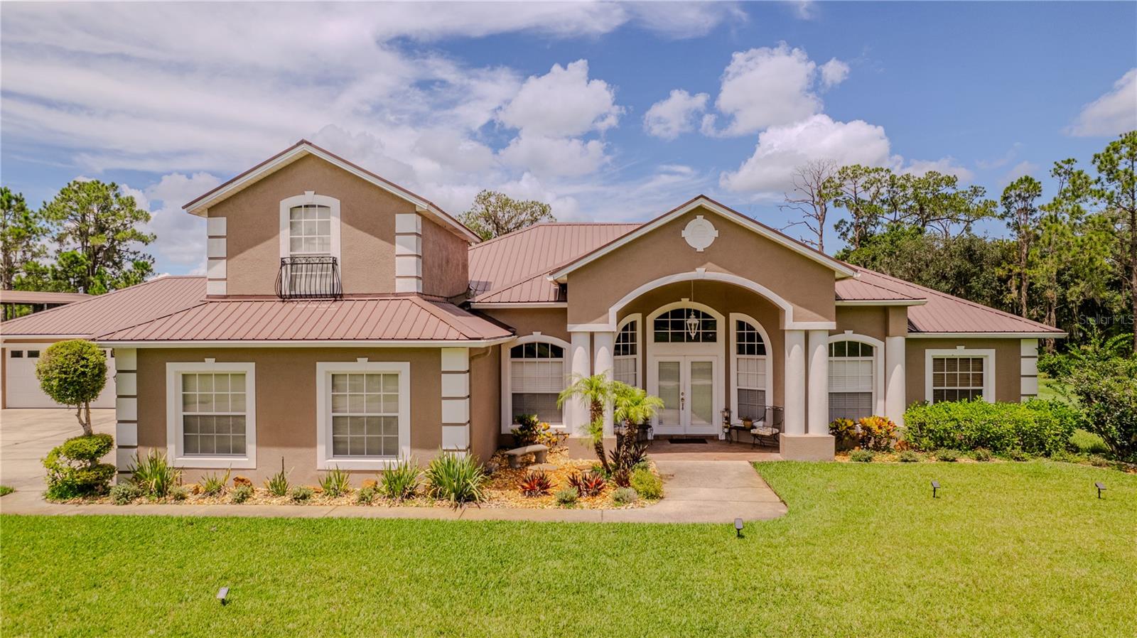 Welcome to your own private paradise! Nestled on 17.13 stunning lakefront acres along the shores of Live Oak Lake, this rare and unique property offers the perfect blend of luxury, privacy, and functionality. With 1,075 feet of direct lake frontage, gorgeous mature trees, and plenty of space to roam, this is the ideal setting for those seeking a waterfront retreat, multigenerational living, or the ultimate homestead.The main home is a spacious 3-bedroom, 3-bathroom residence featuring an open floor plan, a cozy den, and a bonus room for added flexibility. The kitchen, dining, and living spaces flow seamlessly—perfect for entertaining or simply enjoying the serene views. Step outside to your custom-designed pool with a rock cave and waterfall, all just steps from the water’s edge. Additional features include a 14x46 carport, attached 2-car garage, and a detached 2-car garage with a convenient half bath—plenty of room for toys, tools, or extra vehicles.The second home offers 2 bedrooms and 2 bathrooms, with its own lakefront views and private utilities. Whether you're accommodating extended family, guests, or looking for income potential, this home adds flexibility and value to the property.The entire property is fenced with an electric gate, and each home is on its own well, septic system, and electric meter. A massive 30x85 enclosed shop completes the package—ideal for a workshop, business use, RV storage, or hobbyist space.If you're looking for space, peace, privacy, and breathtaking waterfront living just minutes from town, this property is calling your name. Don't miss the opportunity to own a one-of-a-kind lakefront estate like this!