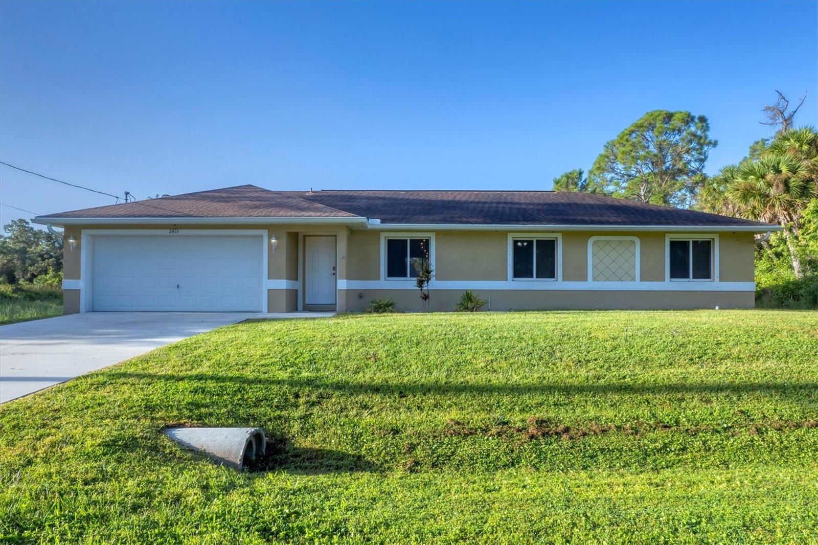 Back on market! Previous contract fell through due to buyer’s financing. Move-in ready 2016 home in desirable North Port Estates situated on an oversized lot in an X flood zone and filled with upgrades! This beautifully maintained 3-bedroom, 2-bath, 2-car garage home offers privacy, modern comfort, and Florida living at its best. Enjoy vaulted ceilings, tile flooring throughout, and an open-concept floor plan ideal for entertaining or relaxing. The kitchen features granite countertops, matching backsplash, hardwood cabinetry and a breakfast bar with pendant lighting. The primary suite includes ample closet space with an ensuite bathroom that has a granite-topped vanity and a linen closet. With two guest bedrooms and a second full bath for family or friends. Step outside to a screened-in lanai and beautiful backyard surrounded by nature and frequent wildlife sightings. Additional features include hurricane shutters, a new AC coil (May 2024), monthly serviced well filtration system, updated light fixtures, Ring doorbell, garage door opener, fiber optic WiFi hookup and all appliances. Located just minutes to I-75, US-41, shopping, dining, nature parks, and sandy beaches—schedule your private showing today!