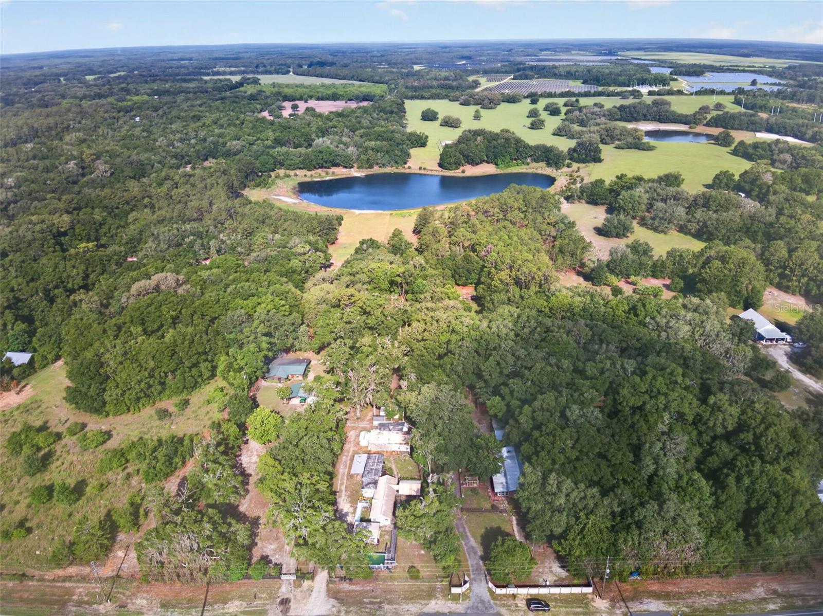 This spacious 3 BR/2BA sweet country home sits on over 3 acres on a lake with a barn, storage shed and beautiful garden views. Nestled just minutes from the artsy town of Melrose, downtown dining and Lake Santa Fe. The whole home sings with eclectic features and a promise to give you the country feel you are looking for.  The living room is oversized with plenty of room for game night. There is a dining room off the kitchen and separate laundry room.  There is even a separate storage room. While the home does need a little TLC, the location, acreage and price offer a fantastic value. Come put your stamp on this beautiful property!