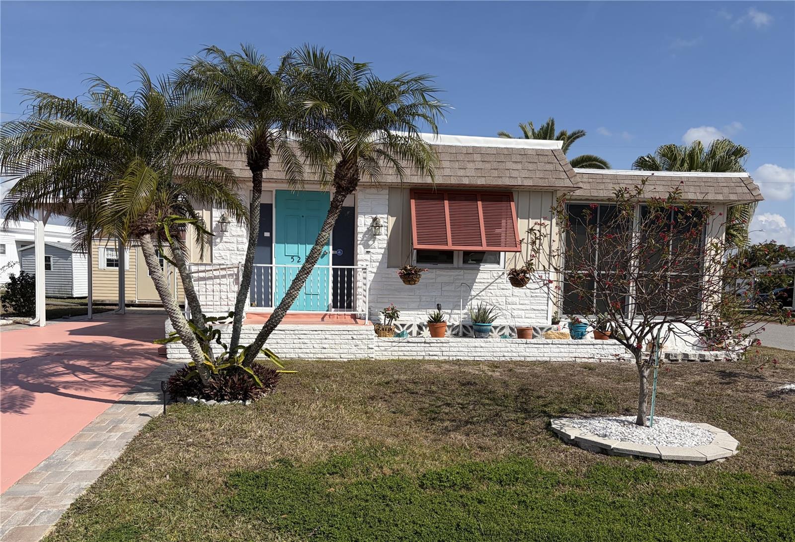 Tri-par Estates in an active, vibrant 55+ community where each property is individually owned with a deed and title to the home. This large corner lot is NOT in the flood zone, but IS in the pet-friendly area and the homes comes furnished. The open living/dining combo is spacious and bright with updated windows, mostly 2025- low-e/double-pane. Other updates include vinyl planking floor throughout, kitchen, bathrooms, all appliances newer including water heater, and freshly painted throughout. The main washroom features a step-in shower, and the primary ensuite has a tub with shower. The laundry is located inside the home for your easy convenience. Public records indicate 880 sq ft for the main house; a mini-split unit has been added to the all-season Florida room for a total of 1,060 sq ft. Outside updates include: TPO roof- 2025, aluminum carport - 2026, pavers -2025, electrical box, garden sprinkler system, and addition of a 10' x 14' shed which provides tons of space for all your storage needs. Tri-par provides a wealth of amenities: enjoy the heated/cooled Olympic-sized for year round swimming, newly constructed large hot tub, palapa tiki hut, pickleball courts, fitness center, shuffleboard courts, miniature golf, horseshoes, game rooms for ping-pong, billiards and more. The clubhouse is host to events such as dinners, dances, and celebrations of all kinds. Situated only minutes from downtown Sarasota, museums, shopping, eateries, the airport and of course the world-renowned Siesta Key and Lido key beaches! You own your own land in this special parks and recreation district, and pay no HOA fee directly to the association. The annual amount of $1,648 is included in your property taxes, and includes such items as fiber-optic internet and direct TV- many channels. Golf cart-friendly community with optional storage for your R/V or boat.