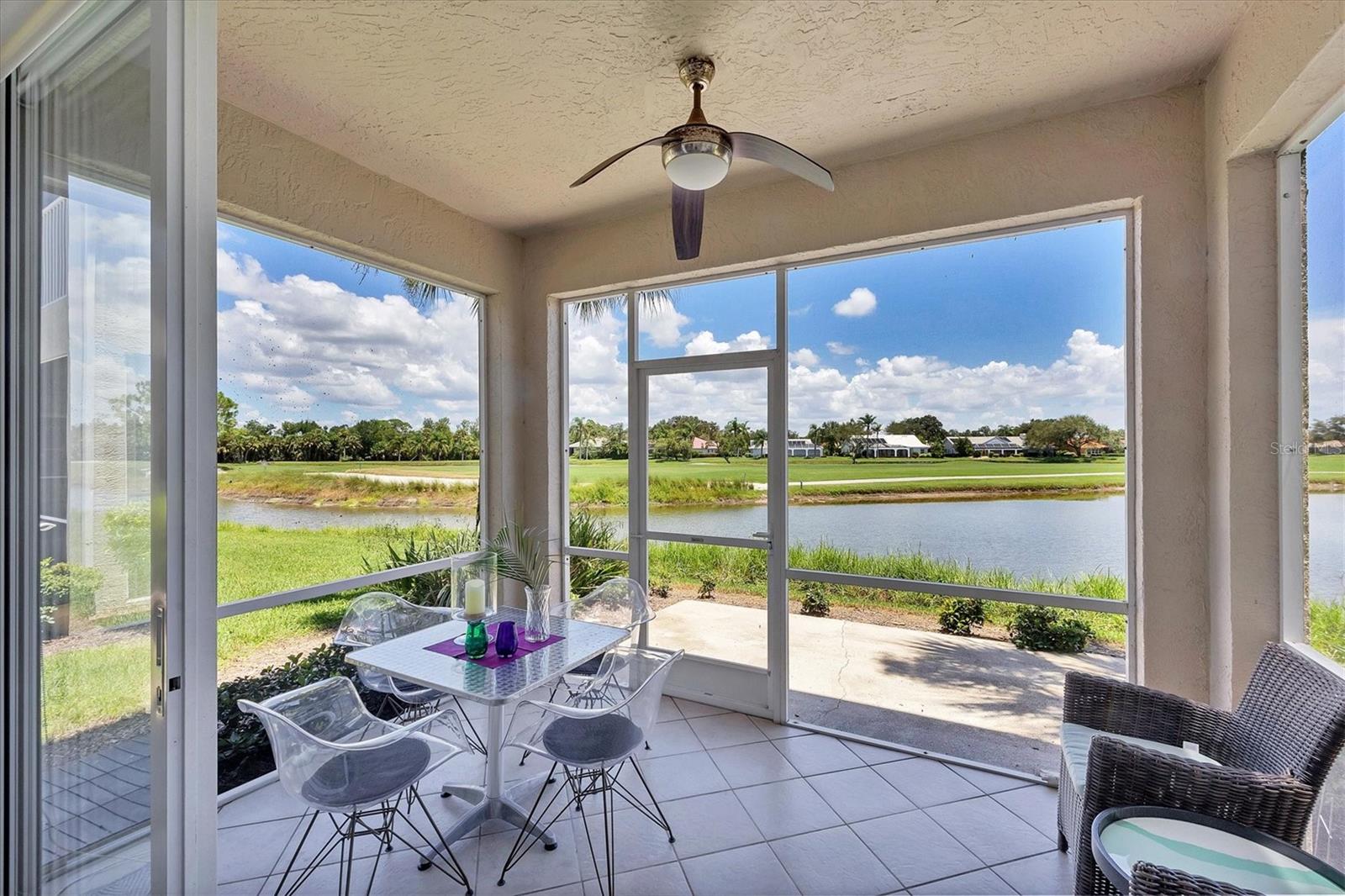 Live in style with unmatched views! Enter into elegance with this beautifully furnished and tastefully decorated ground-floor condominium, offering panoramic views of the shimmering lake and lush golf course. In the sought-after Fairway Glen at St. Andrews Park within The Plantation Golf & Country Club, this spacious residence combines comfort, style, and a spectacular setting. Inside, you'll find a large kitchen with stainless steel appliances and granite countertops and an inviting dining area, a bright and airy living room, and an adjoining bonus space, ideal as a cozy reading nook or a den for work or hobbies, all while enjoying the breathtaking scenery. Go outside to the screened-in porch and unwind with your morning coffee or evening drink as you soak in the peaceful views. This amazing and immaculate and hardly lived in property features two generously sized bedrooms and two full baths, offering privacy and flexibility. A one-car garage, an additional designated parking spot plus guest parking provides convenience and practicality. Air conditioning is only 2 years old. Meet your friends and neighbors at one of the pools or dine at the elegant clubhouse's regarded restaurant. For more activities, you can enjoy optional memberships to the prestigious Plantation Golf & Country Club, which offers access to golf, tennis, pickleball, bocce ball and a state-of-the-art fitness center with personal trainers. Ideally near shopping, dining and just minutes from Venice's pristine sandy beaches, this is the ideal home for seasonal or year-round living. Also, a short ride to the vibrant downtown district with its quaint shops, cafes and restaurants.