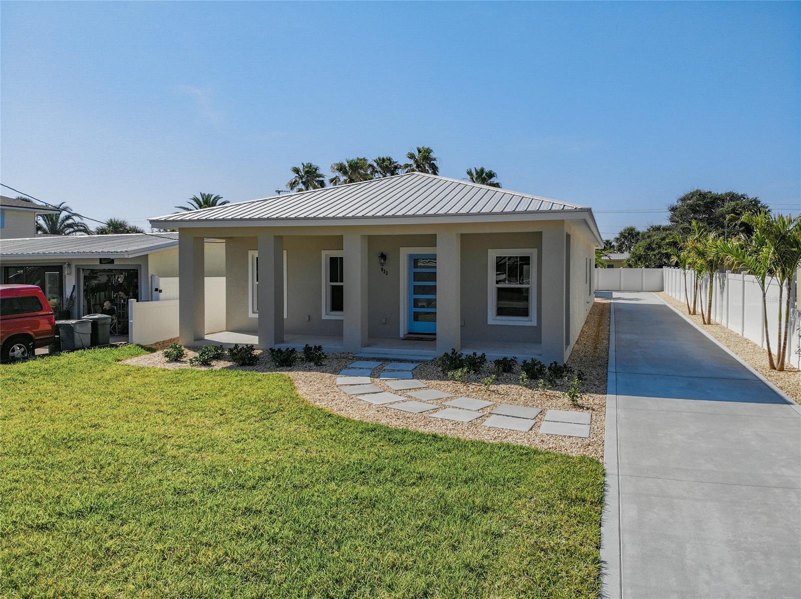NEW CONSTRUCTION COMPLETED APRIL 2021!
3 bedroom 2 and ½ bath beach home behind Izzy’s on S Atlantic. Built by Redd Construction focusing on style and detail. When you open the front door you will be in the living room which is open to the kitchen and dining area. Right off the living room are 2 bedrooms with custom closets and 1 full bathroom.  The master bedroom and  master bath are spacious with a functional custom closet off the master bath. Throughout the house is vinyl plank flooring. The kitchen has GE monogram appliances and Cambria counter tops. The laundry room is off the dining room with built-in cabinets. When you go out to the back of the house there is an air-conditioned storage closet on the left with a tankless hot water heater. The house has a metal roof, new impact windows and doors, new A/C, outdoor lighting, wired for a security camera’s, vinyl fenced low maintenance yard with an irrigation system. When you return from your day at the beach you can shower off in the outside shower. The 2-car garage is in the back of the house with a breezeway to the back porch and entry to the house. Walk across the street to New Smyrna’s beautiful beach. Restaurants, Our Lady of the Sea Church, grocery shopping and other businesses within walking distance.  Call today to see this beautiful beach house in person or virtually! ;Water: City