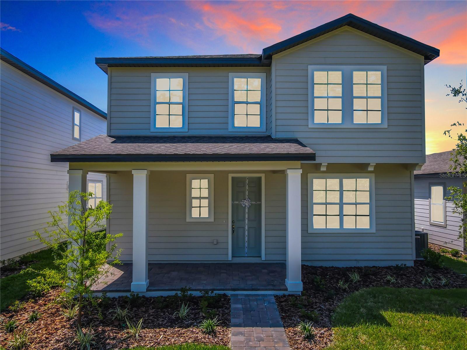 Welcome to this stunning, nearly new home, just two years old and thoughtfully designed for modern living. Perfectly positioned directly across from a beautiful conservation area and just steps from the community amenities center, this exceptional residence offers the ideal blend of comfort, convenience, and style.

As you enter through the inviting front porch, you'll find a private first-floor bedroom and full bathroom—perfect for guests, in-laws, or a home office. The heart of the home features a gourmet kitchen that seamlessly flows into the spacious open-concept living and dining areas, creating the perfect space for entertaining and everyday living.

Step through elegant French doors to enjoy the extended covered lanai and side yard, offering plenty of outdoor living space. The oversized driveway and two-car garage provide ample parking and storage.

Upstairs, you'll discover two additional bedrooms, a full bathroom, and an expansive primary suite designed as a true retreat. The luxurious primary bathroom features dual vanities, an oversized walk-in shower, and a spacious walk-in closet.

Located within a highly sought-after school district and just minutes from Orlando Health Hospital, Hamlin Town Center, and Flamingo Crossings Town Center, this home offers unparalleled convenience to shopping, dining, entertainment, and major roadways.

This move-in-ready gem truly has everything you've been looking for. Schedule your private showing today and experience the lifestyle this exceptional home has to offer!