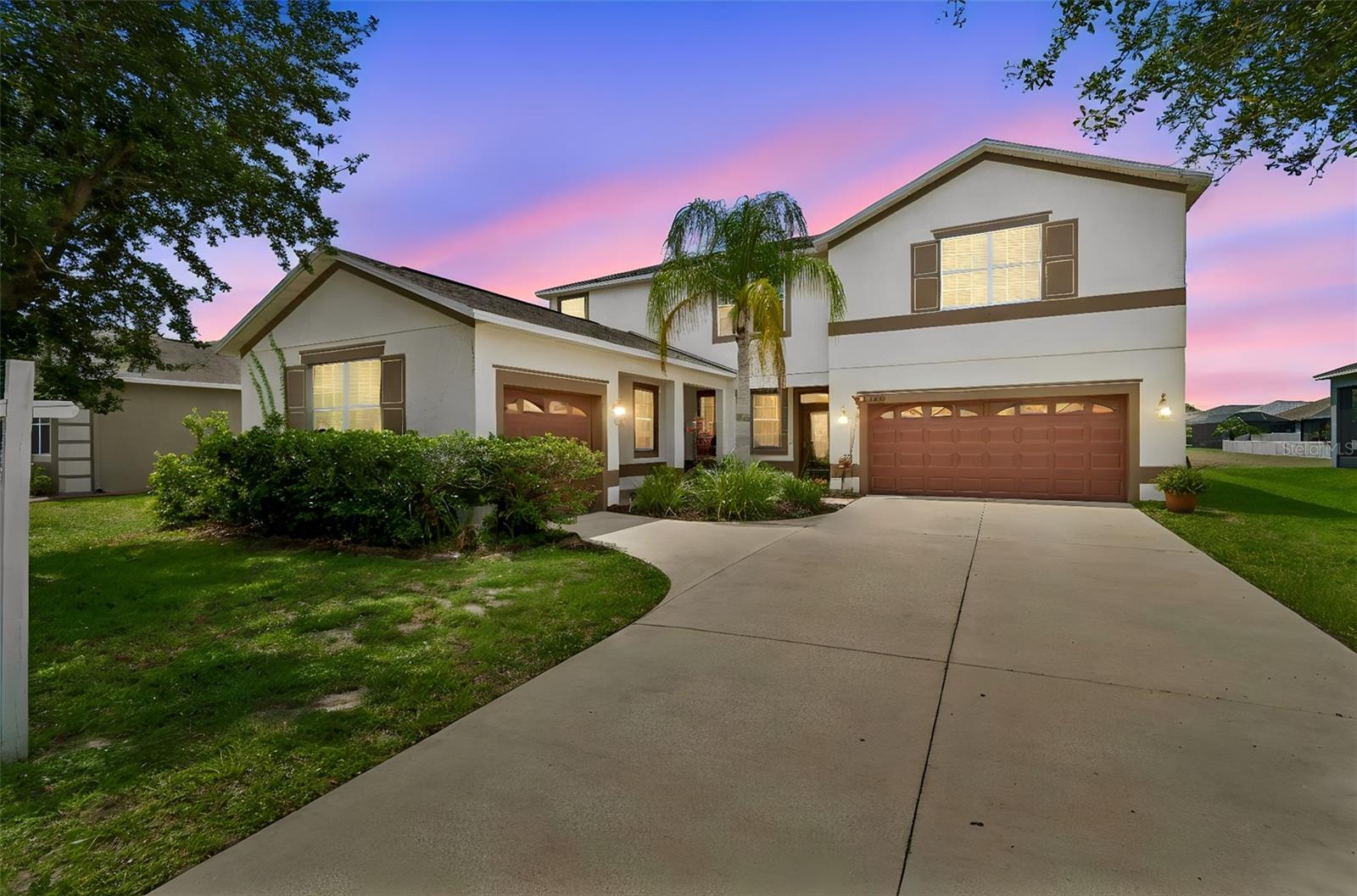 This South Fork home offers nearly 3,000 square feet with 4 bedrooms, 3.5 baths, and a 3-car garage. Step through the front door and the living room stops you. Soaring ceilings stretch overhead, a dramatic accent wall commands the space, and rich hardwood floors carry you through to the the family room. The kitchen earns its own moment — granite countertops, herringbone tile backsplash, pendant lighting over a generous island, and stainless appliances including a brand-new refrigerator and microwave (2025). It's the kind of kitchen that actually gets used.
Hardwood flooring adds warmth to the living room, dining room, family room, and staircase, while durable vinyl tile extends throughout the bedrooms.  Upstairs, the primary suite is bright and genuinely oversized, with a large picture window and walk-in closets. One of the three additional bedrooms has its own ensuite — a detail that changes everything for guests or multi-generational living.
Then there's the bonus room — a flex space with a built-in navy accent shelving wall, recessed lighting, call it a reading room, a home office, a creative studio, or all three at different times.  A new washer and dryer (2025) are also included. 
The 2023 screened lanai completes the picture with it's water view that makes $484,900 feel like a genuine find.
Community amenities include a pool, dog park, playgrounds, and walking trails, with convenient access to I-75, shopping, dining, and major commuter routes.
