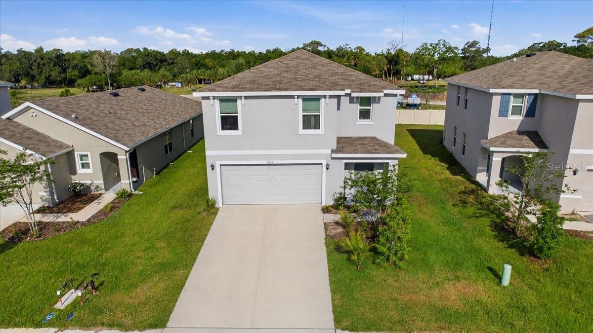 One or more photo(s) has been virtually staged.This all-concrete block constructed, two-story plan has a large open-concept downstairs which includes a well-appointed kitchen, living and dining area, and an outdoor patio. Upstairs, the oversized owner’s suite can easily fit a king-size bed and includes a large walk-in closet as well as an ensuite bathroom with double vanity. Three other bedrooms share a second upstairs bathroom while the loft provides an extra area for work or play. This home comes with refrigerator, built-in dishwasher, electric range, and microwave as well as washer and dryer. Pictures, photographs, colors, features, and sizes are for illustration purposes only and will vary from the homes as built. Home and community information including pricing included features, terms, availability, and amenities are subject to change and prior sale at any time without notice or obligation. Room Feature: Linen Closet In Bath (Primary Bedroom).