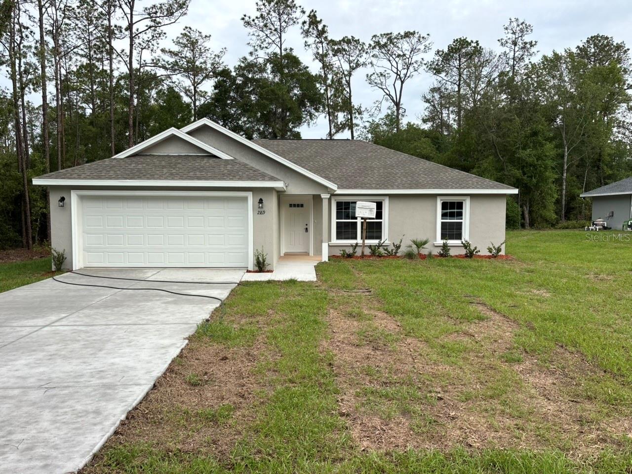 NEW CONSTRUCTION. MOVE-IN READY! This Key West Model in Citrus Springs offers 3 bedrooms, 2 bathrooms, and 1,405 square feet of comfortable living space on an oversized lot. Built with quality in mind, this home features concrete block construction, a 30-year architectural shingle roof, energy-efficient double-pane windows, luxury vinyl plank flooring throughout, and vaulted ceilings in the main living area. The kitchen includes stainless steel appliances, custom white shaker cabinets with soft-close drawers, granite countertops, and a pantry, while the bathrooms also feature granite countertops for a clean and polished finish. Enjoy washer and dryer hookups, a covered patio, and an attached 2-car garage with opener and remotes. This home also includes a 10-year structural warranty, ownership freedom with no HOA fees, and a high-and-dry, flood zone X location with no flood insurance required.