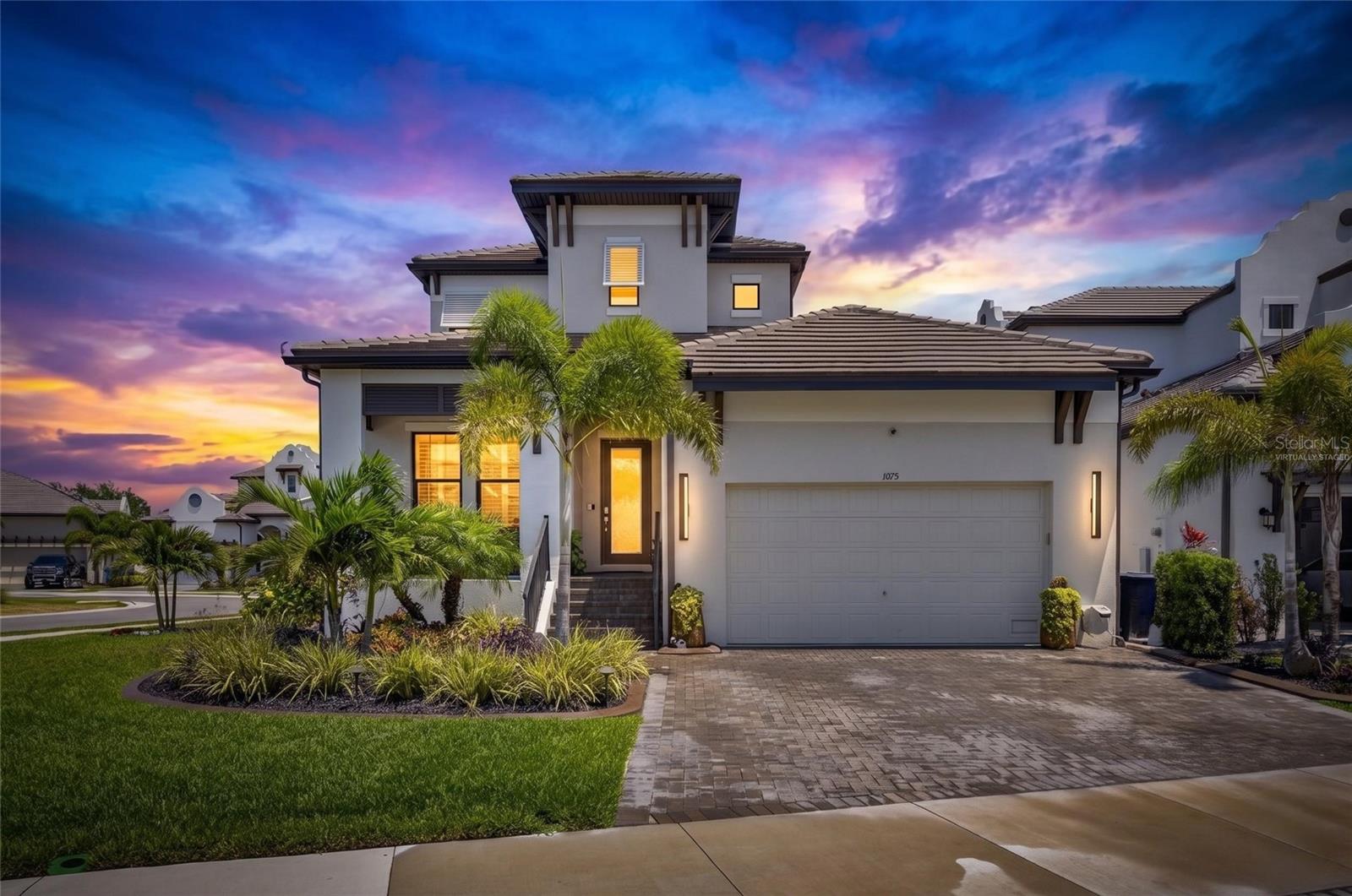 Luxury Pool Home in Antigua Cove | 1075 Seagrape Dr, Ruskin, FL 33570 | 3 Bedroom | 2.5 Bathroom | 2,571 sq ft | 2 Car Garage | Gated | Fenced

Seller offering $12,000 towards buyer's closing costs. & an additional $8,000.00 with preferred lender. $20,000.00 total. Welcome to coastal luxury living in the exclusive gated community of Little Harbor. This highly upgraded 3-bedroom, 2.5-bathroom home with a 2-car garage and 2,571 sq ft is perfectly positioned on a premium corner lot in Antigua Cove, offering designer finishes, a resort-style pool, and exceptional indoor-outdoor living.

From the moment you arrive, you’ll notice the tile roof, pavered driveway, curbed landscape beds, and inviting front porch with a wood inset ceiling. Step through the glass front door into a thoughtfully designed interior featuring wood plank tile flooring throughout, plantation shutters, crown molding, tray ceilings, recessed lighting, and custom architectural wall detailing. The open floor plan offers a main-level office/flex room, a spacious loft upstairs, and a split-bedroom layout for privacy.

The heart of the home is the gourmet kitchen, showcasing an oversized island with seating, pendant lighting, quartz countertops, designer backsplash, farmhouse-style sink, stainless steel appliances, gas cooktop with a custom hood, and TWO full-sized built-in ovens—one featuring smart technology with convection and air fryer capabilities—perfect for entertaining or everyday convenience. White cabinetry with crown molding and a large walk-in pantry with built-ins provide both style and function.

The primary suite is a private retreat with tray ceilings and serene backyard views. The spa-like ensuite features dual vanities with framed mirrors, an oversized glass-enclosed shower with bench and niche, and a custom walk-in closet with premium built-in organization system.

Step outside to your own private resort. The covered and screened lanai includes a ceiling fan and a fully equipped outdoor kitchen with bar seating, grill, refrigerator, and exhaust fan. Overlooking it all is a heated, saltwater infinity-edge pool and spa, surrounded by elegant travertine pavers and accented by stunning fire features, creating the ultimate outdoor ambiance. The fully fenced yard enhances privacy and usability.

Located in Antigua Cove, residents enjoy access to a two-story clubhouse, fitness center, event space, and resort-style pool overlooking the marina. The greater Little Harbor community offers waterfront dining, a tiki bar, tennis courts, a private beach, and a pier on Tampa Bay, all with breathtaking sunset views of the Tampa and St. Petersburg skylines.

Conveniently located near US Hwy 41, this home provides easy access to Tampa, St. Petersburg, and Sarasota, with nearby international airports, major sporting venues, entertainment, Seminole Hard Rock Hotel & Casino Tampa, and world-renowned Gulf Coast beaches.

Furniture is negotiable. This one-of-a-kind home blends luxury, comfort, and lifestyle—schedule your private showing today.