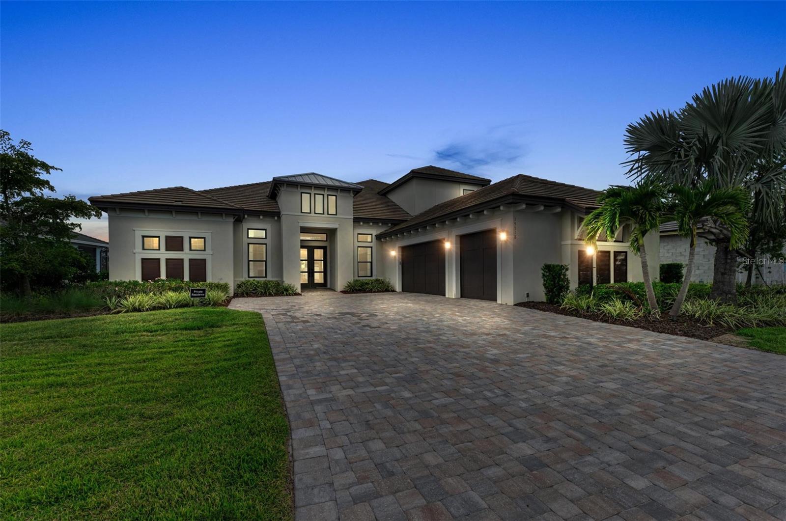 Luxury living at its finest in this Professionally Designed and Decorated model home being sold Fully Furnished in Esplanade at Azario, Lakewood Ranch's finest golf community built by Taylor Morrison. This was one of the largest floor plans that Taylor Morrison offered and the interior designer hand picked every upgrade and the high end furnishings in this Beacon model. Great open floor plan with soaring ceilings with oversized 42 inch cabinets, light color natural stone Kitchen Island. This is a chef's dream kitchen with all Monogram Appliances, including double built in ovens, 6 gas burner range with griddle, pot filler directly over range, two dishwashers for easy clean up, huge walk in panty, dry bar pass through to formal dining room. The tall cabinets offer under cabinet task lighting that wrap around the whole kitchen with glass front display cabinets on top. This designer fully furnished model home has all highest level furnishings throughout. The master suite is located on the first floor with pool, lake, golf course and sunset views. Two walk in closets and an enormous walk in shower with his and her sides with rainfall shower heads are a must see. The home offers a media room with huge sectional for movie night with views of the lake and outdoor pool area. Additional study/den for work area, the second floor offers en suite bedroom with mini kitchen and separate gathering room area great for game night or movies centered on another huge sectional sofa for guest to relax or kid area. The extraordinary outdoor living space with frameless screened enclosure views of the lake, golf course and amazing sunsets. The most comfy outdoor furniture surrounds the heated pool and spa. The outdoor kitchen area is a great spot for outdoor entertainment. Azario offers state of the art amenities, 18 hole golf course, pro shop & Bunker bar, Aqua driving range, culinary center with multiple dining options, spa and wellness center, resort pool and bar area, Fitness center, all kinds of sports courts, walking trails, a variety of community gardens to enjoy, fire pit area, meeting and activity center and more.