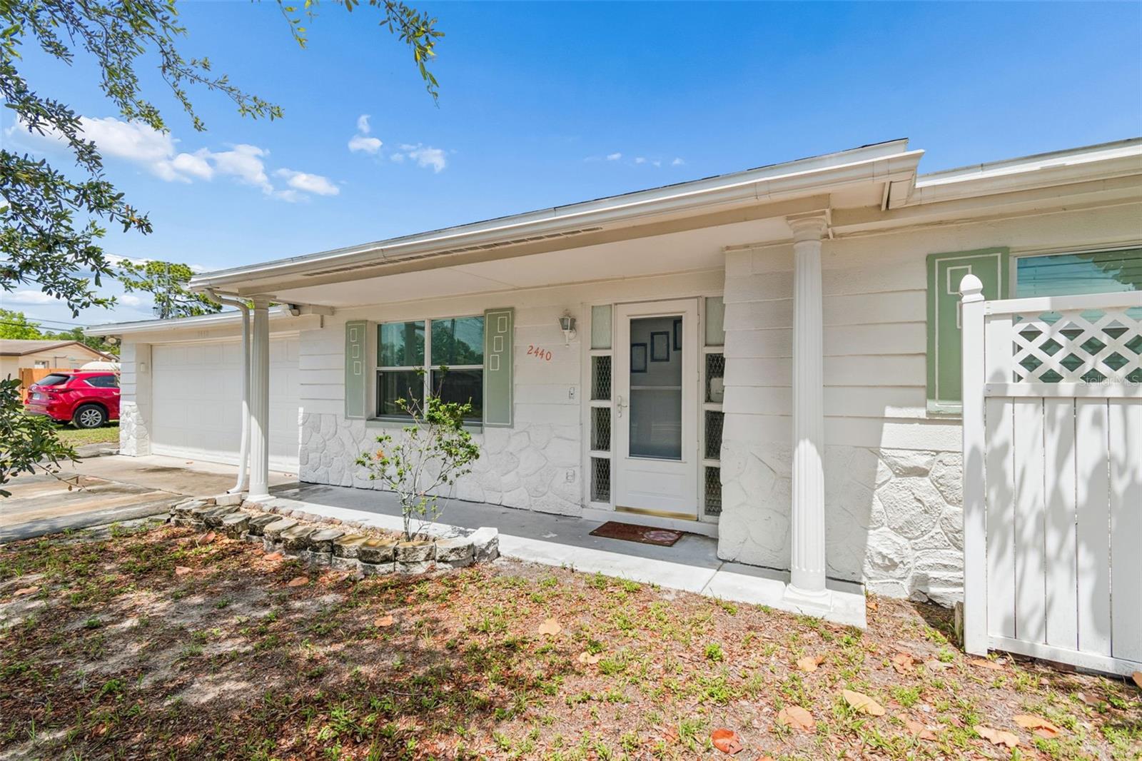 Welcome to this beautifully updated 3 bedroom, 2 bathroom home offering the perfect blend of privacy, functionality, and modern Florida living. Located on a quiet street with no direct front neighbors and added privacy from a neighboring water department-owned lot, this move in ready property is conveniently close to shopping, dining, parks, schools, medical facilities, and Gulf beaches. Inside, you’ll find a bright open-concept layout with abundant natural light, spacious living areas, and durable tile flooring throughout most of the home. The updated kitchen features newer countertops, newer refrigerator, extensive cabinetry, built-in pantry storage, and oversized bar seating ideal for entertaining. The split-bedroom floor plan provides added privacy, while the spacious primary suite offers excellent closet space. Outside, enjoy the oversized fenced backyard with covered outdoor living space, patio area, and plenty of room for pets, gardening, or a future pool. Additional highlights include fresh exterior paint, updated windows, oversized 2-car garage, covered front porch, and rear covered porch. Whether you're searching for a primary residence, seasonal getaway, or investment opportunity, this well-maintained Holiday home offers exceptional value and convenience. (ROOF-2013)(FLAT ROOF-2023)(A/C-2015)